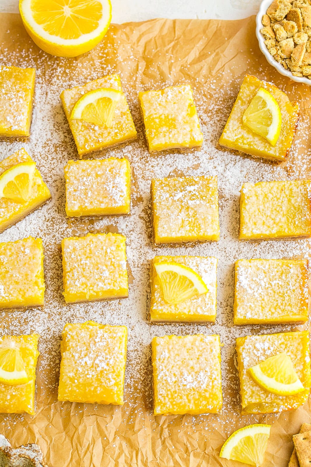Lemon Bars with Graham Cracker Crust on parchment paper. 
