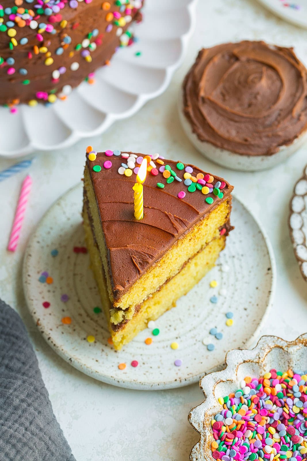 Yellow Birthday Cake slice with candle.