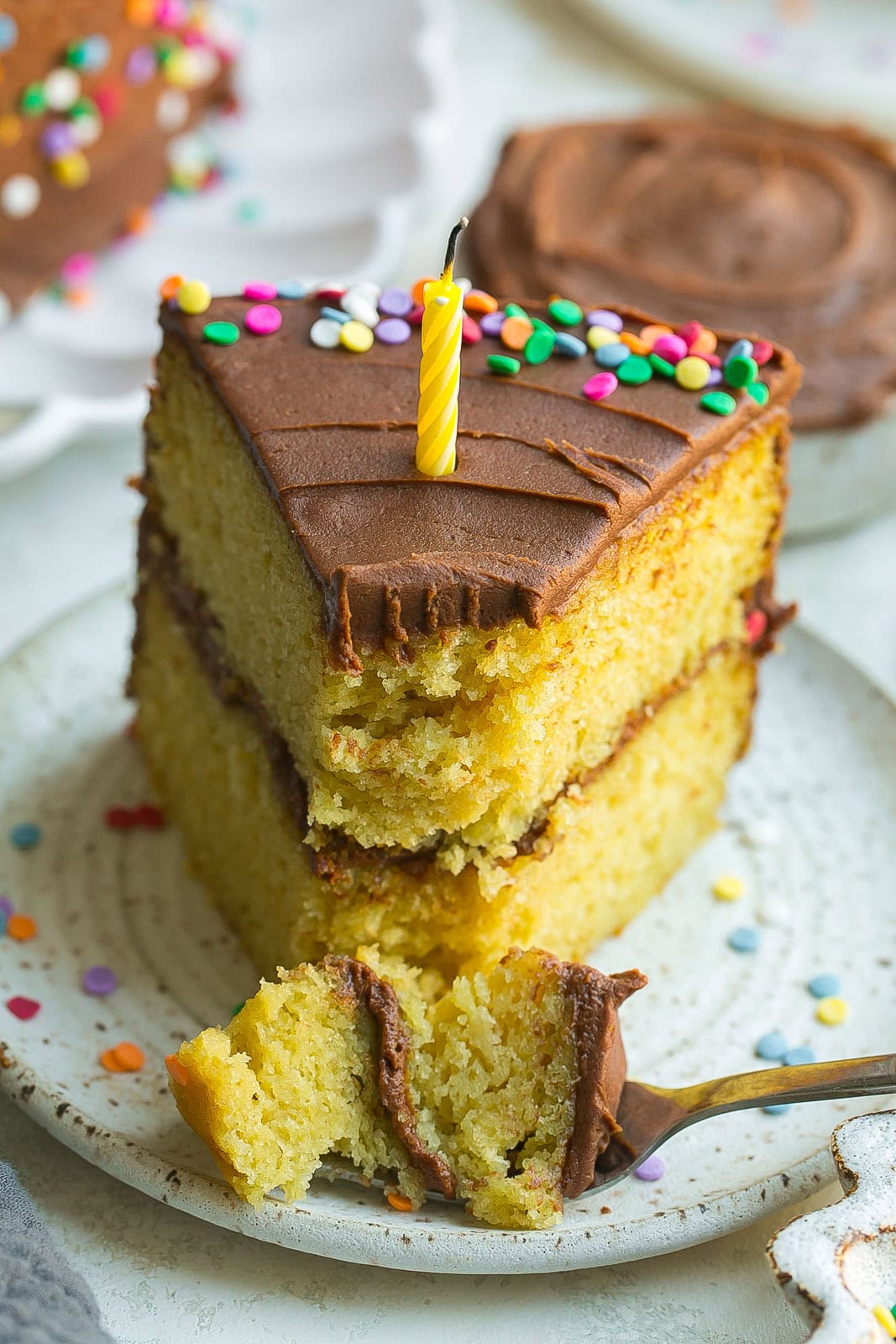 Close up of yellow cake with chocolate frosting. 