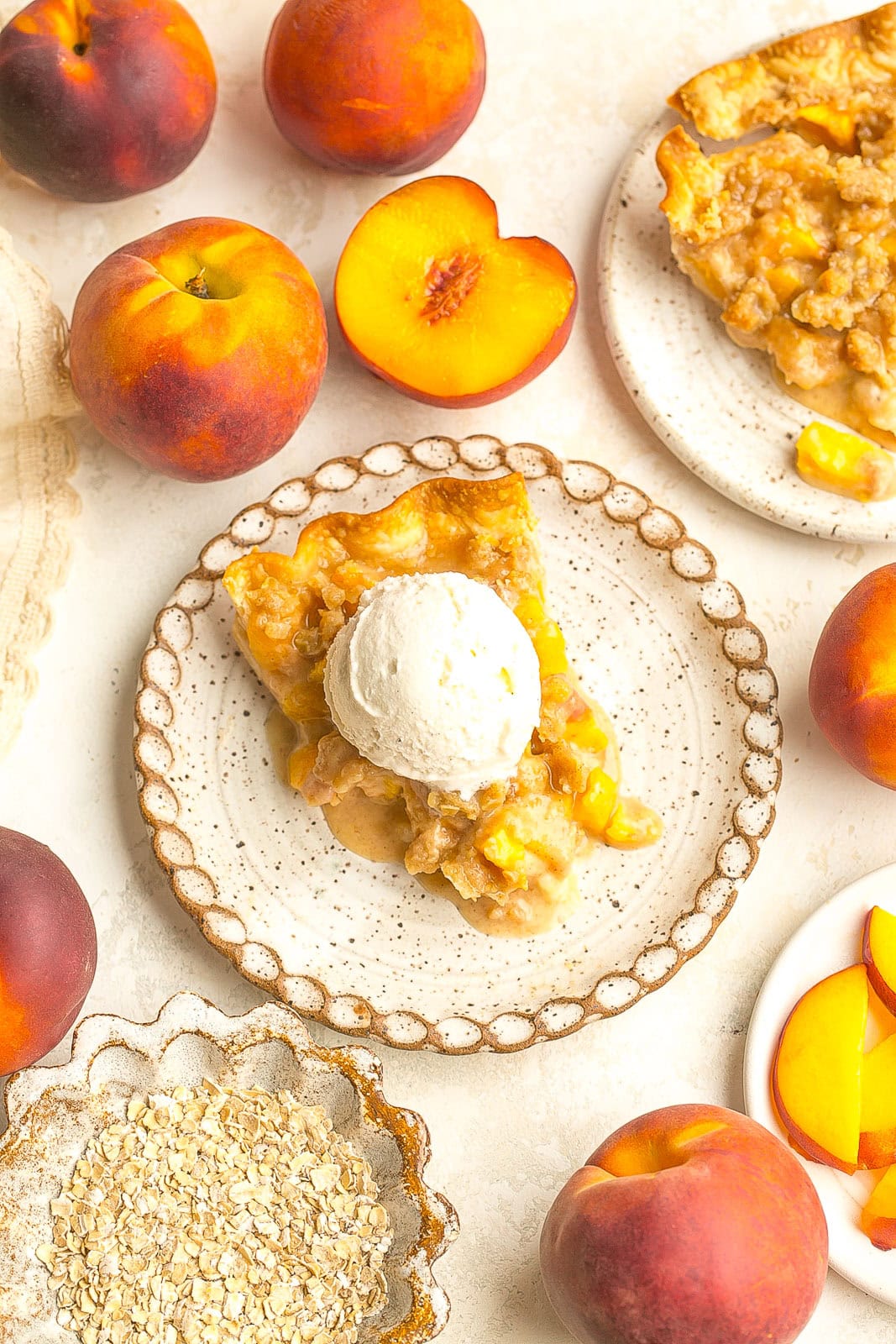 Slice of Peach Crumble Pie on plate.