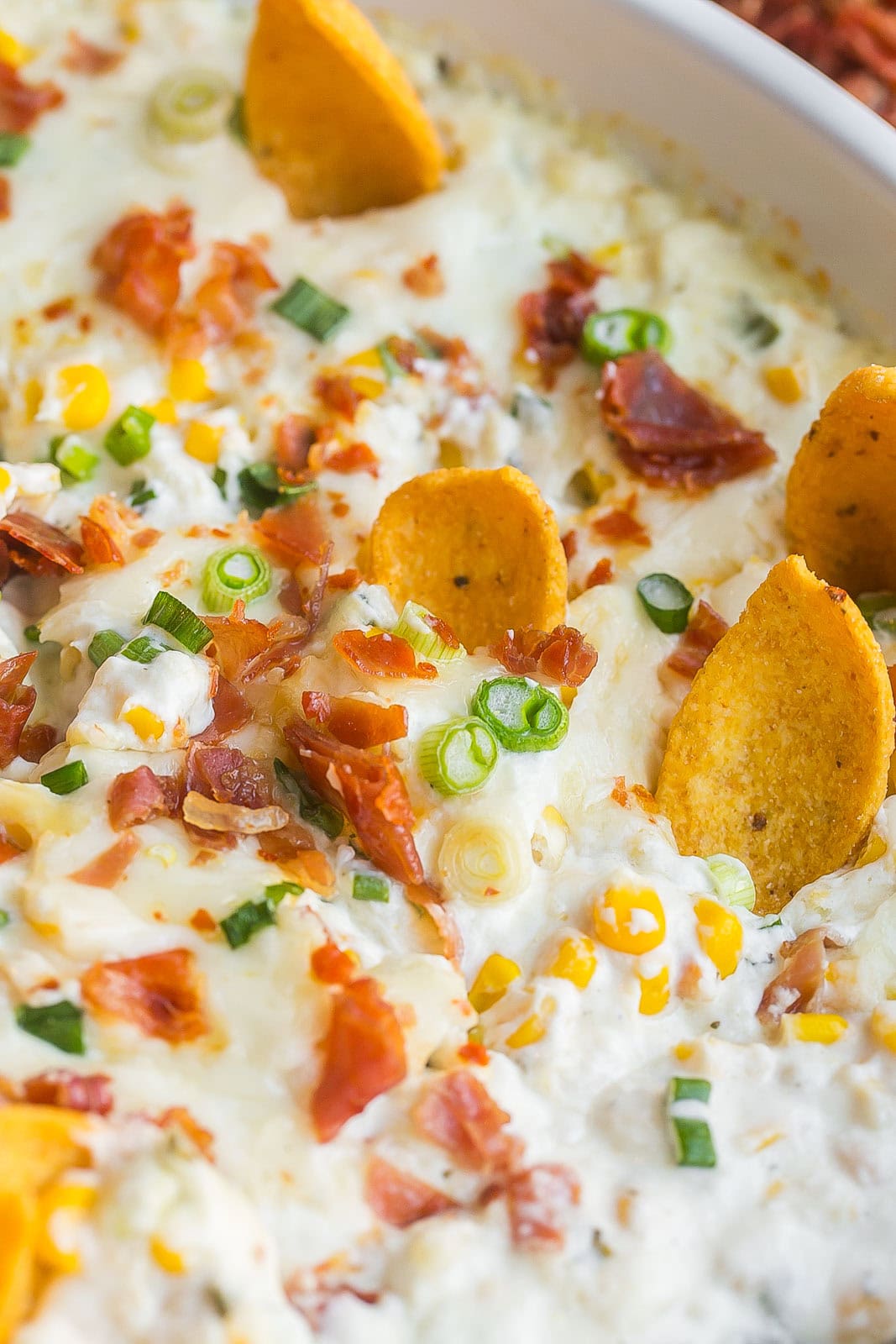 Top view of baked cheese dip with corn.