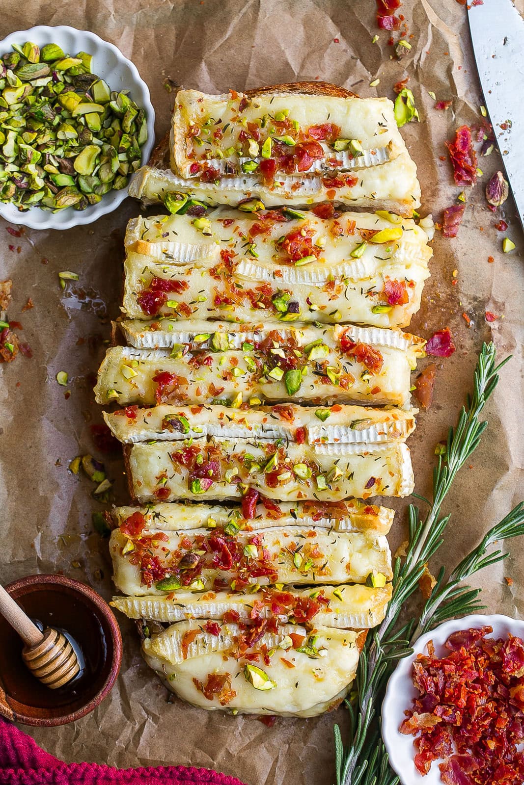 Brie Bread with hot honey, crispy prosciutto and pistachios on top.