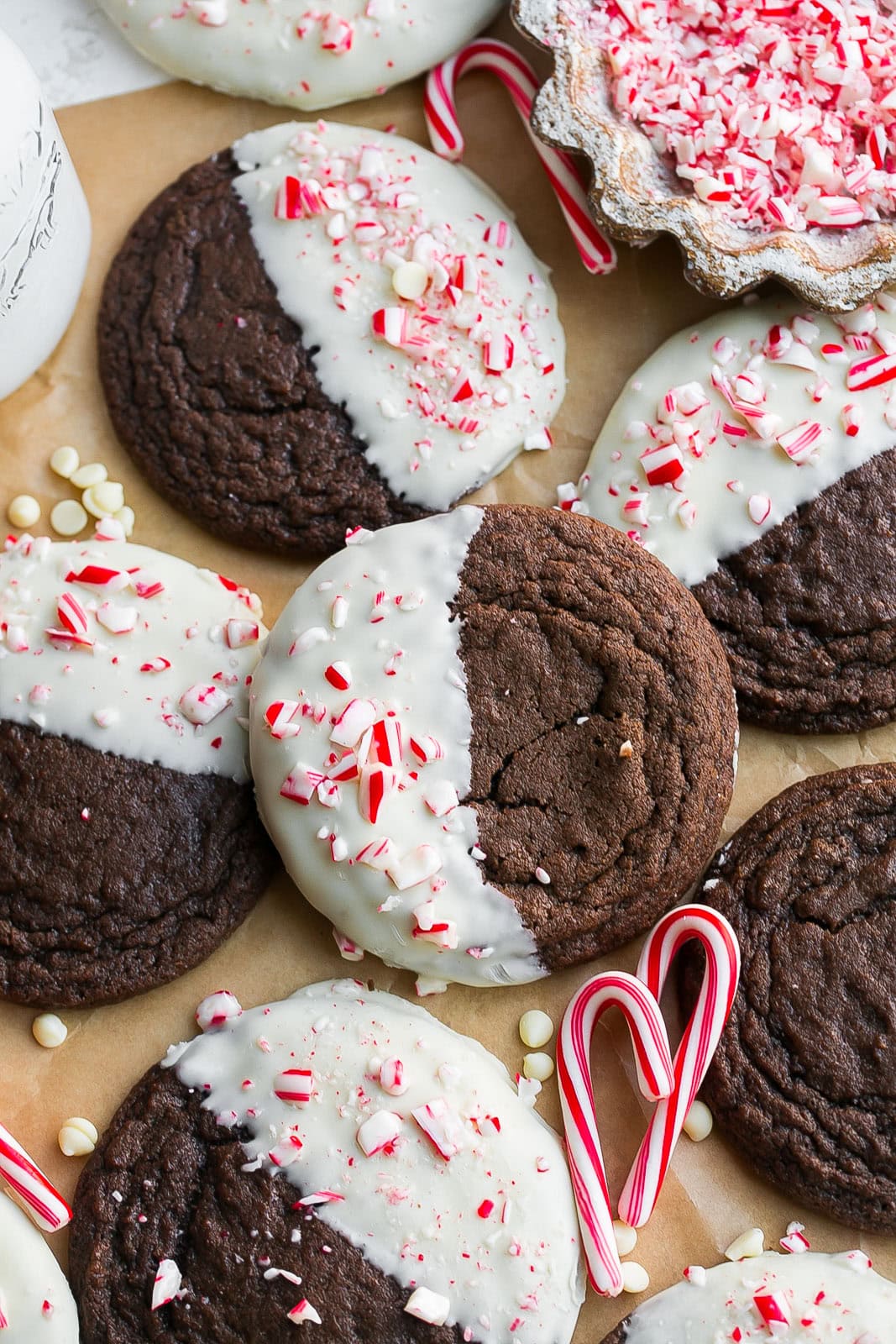 Peppermint Brownie Cookies on parchment paper with crushed candy canes.