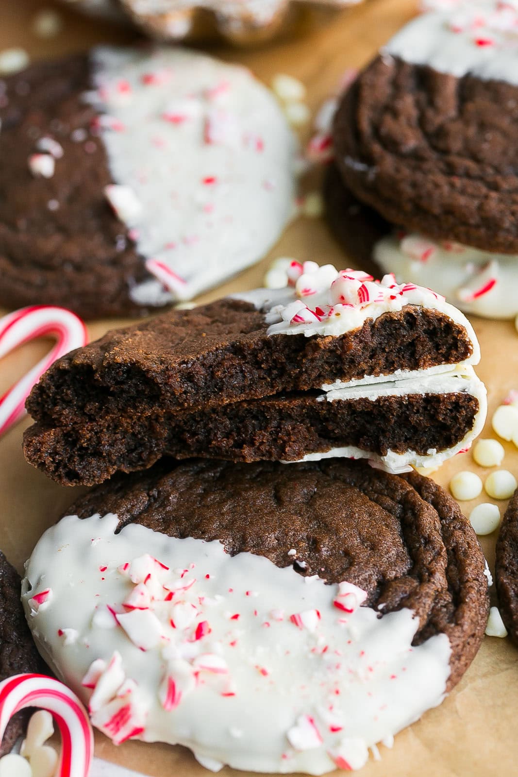 Inside of a fudgy chocolate brownie cookie with white chocolate and peppermint candies.