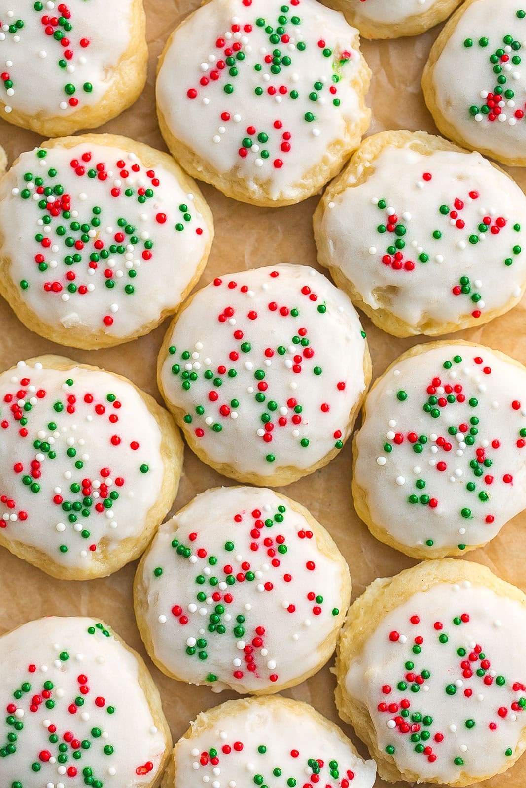Close up of Sour Cream Cookies with icing and sprinkles.