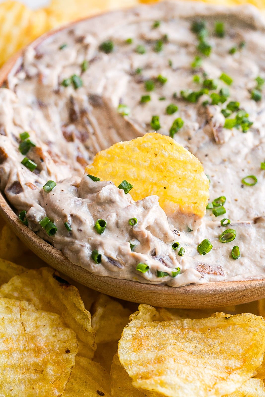 HOmemade French Onion Dip with potato chip in the middle of the bow.c