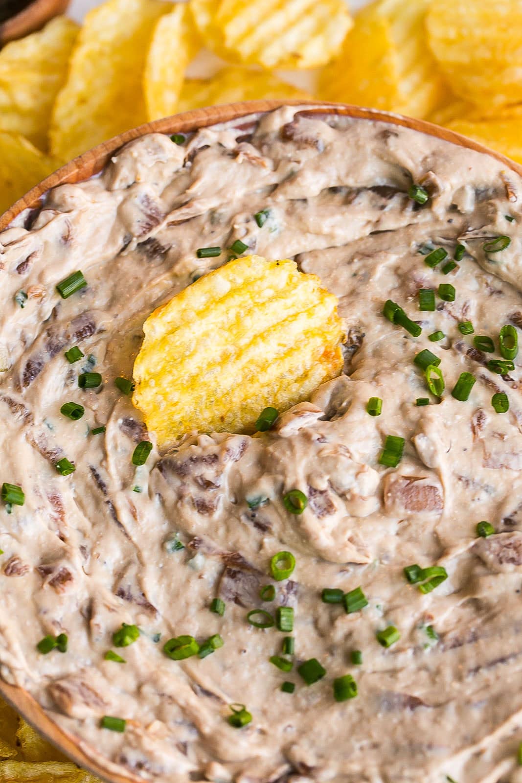 Onion dip from scratch with fresh chives on top.