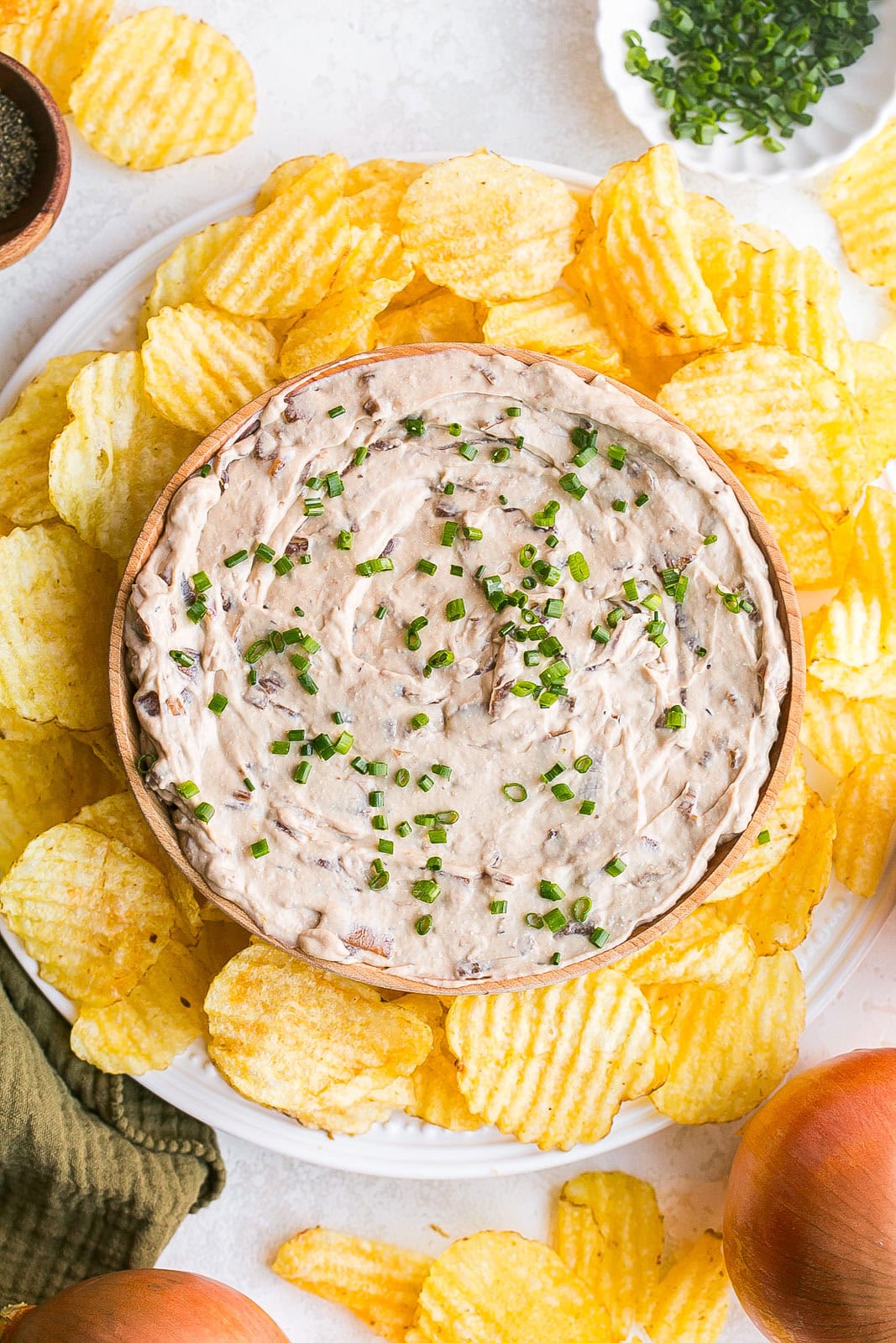French Onion Dip recipe in a bowl with potato chips around it.