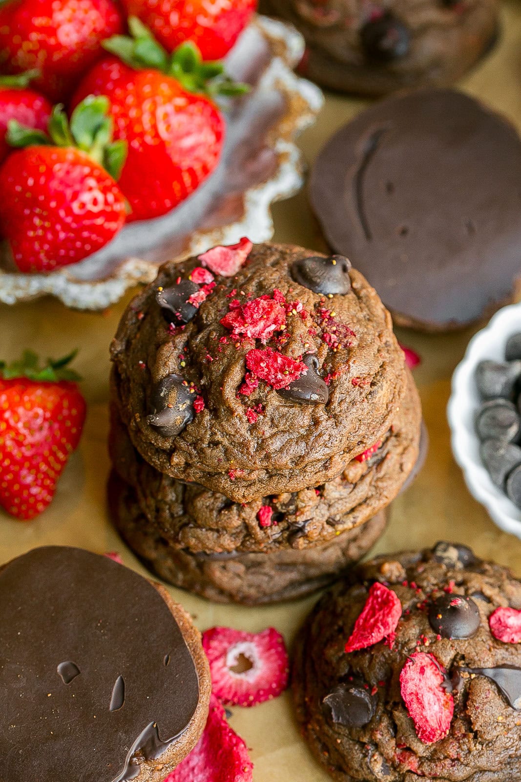 A stack of chocolate cookies with freeze-dried strawberries.