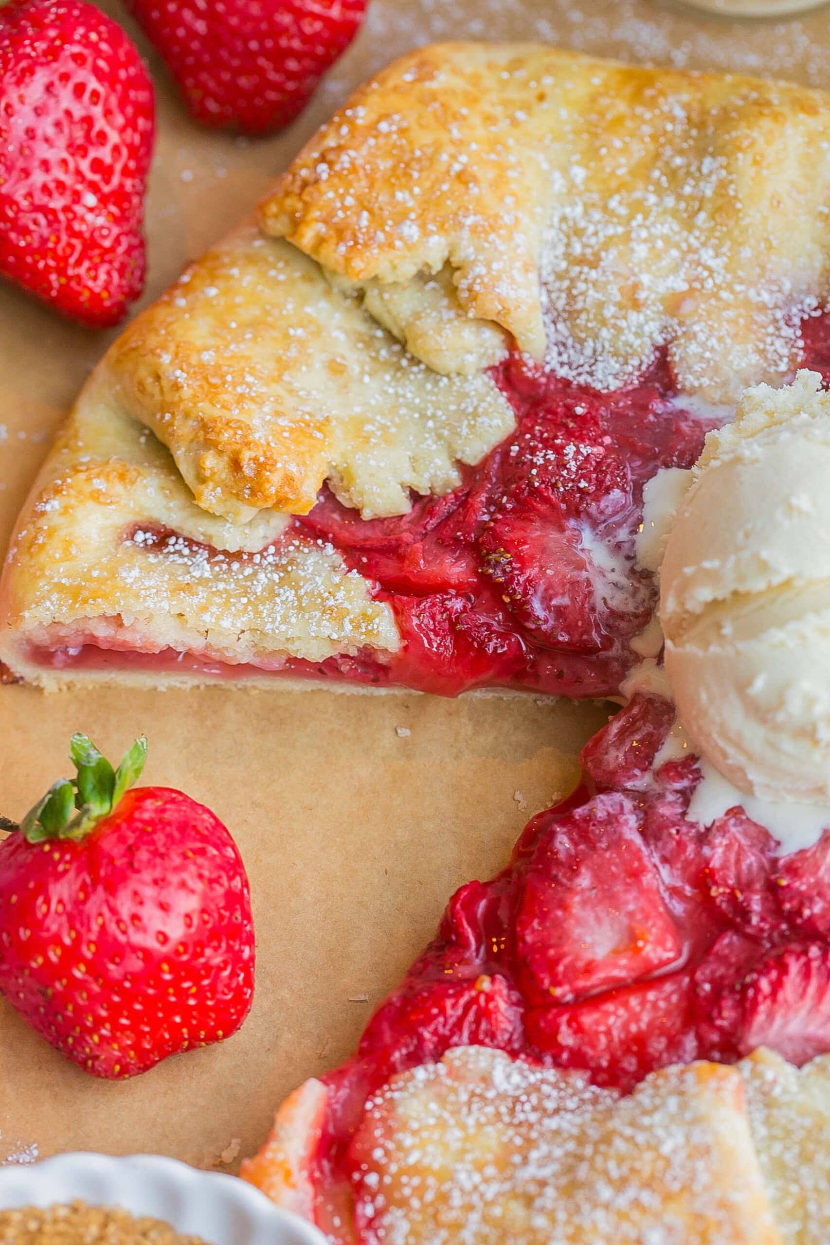 Strawberry galette with pie crust with slice.