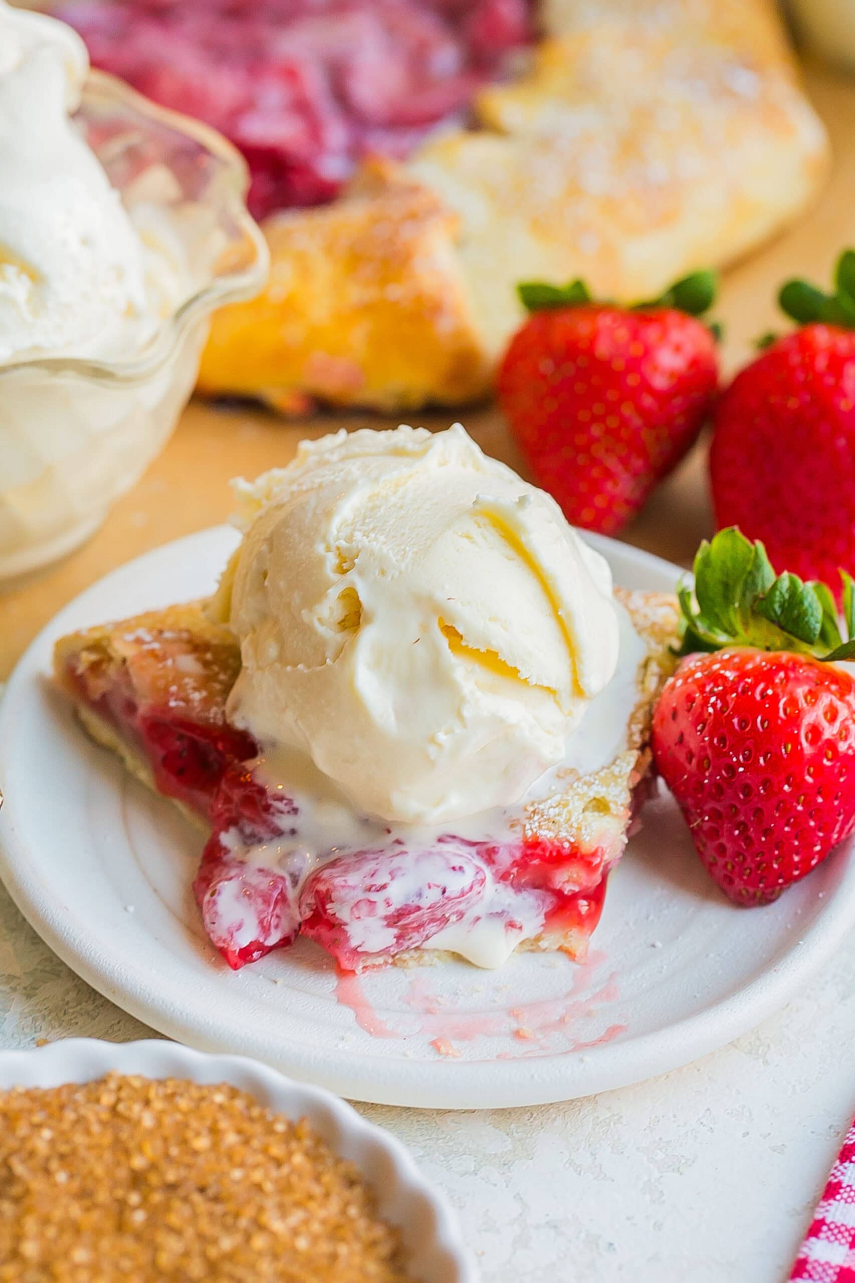 Strawberry Galette slice with ice cream melting on top.