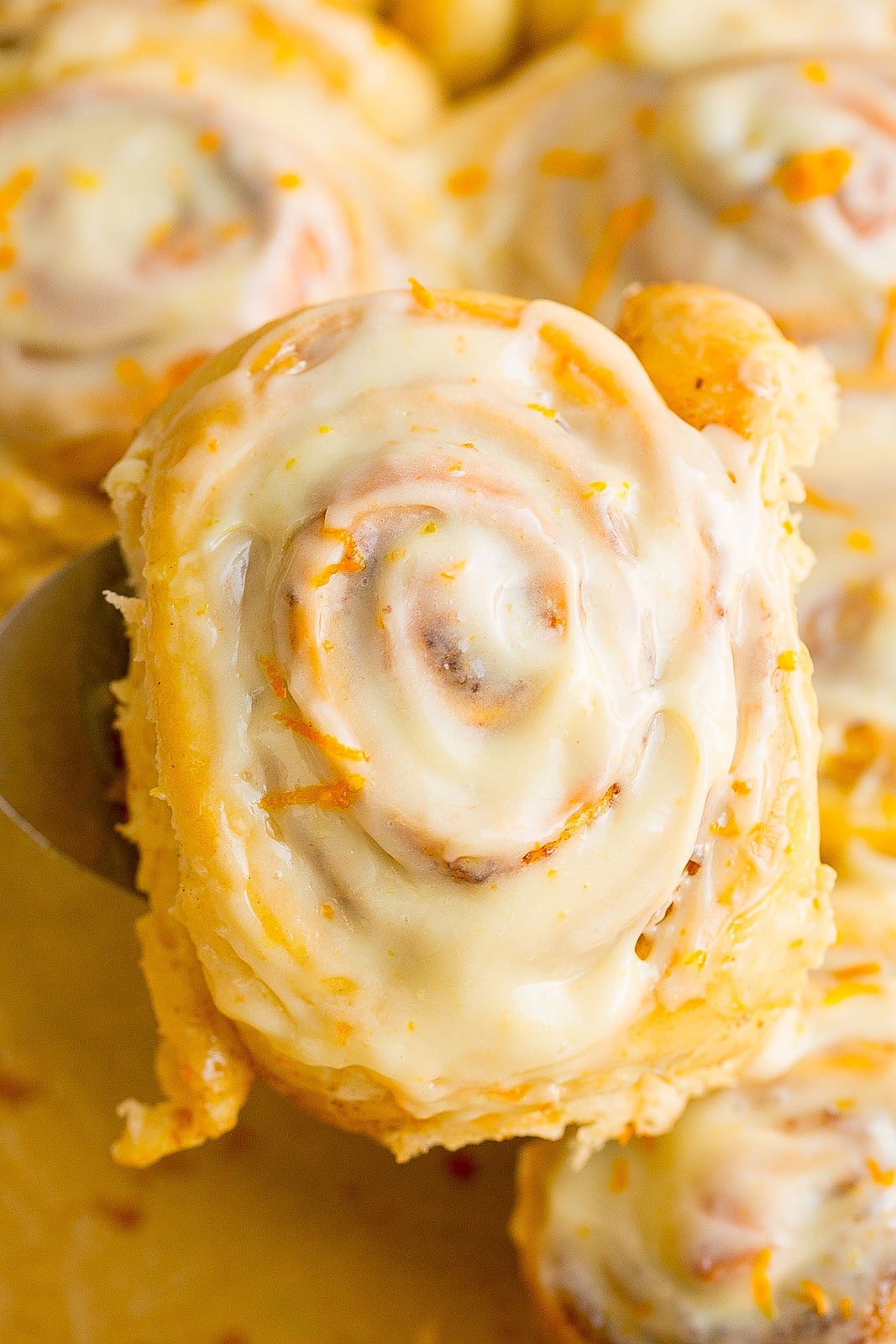 Close up of an Iced Orange Sweet Roll.