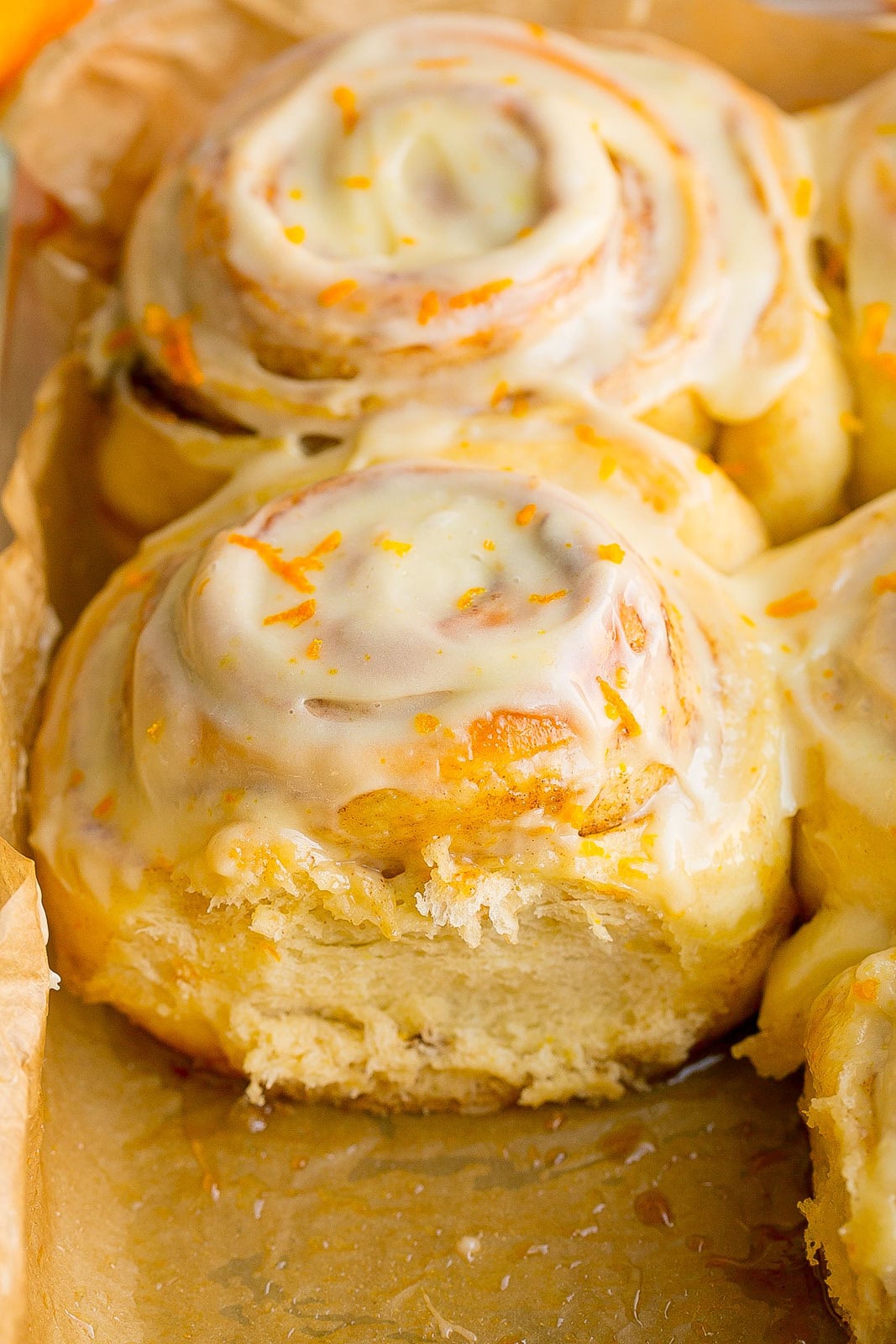 Close up side view of fluffy Orange Sweet Rolls.