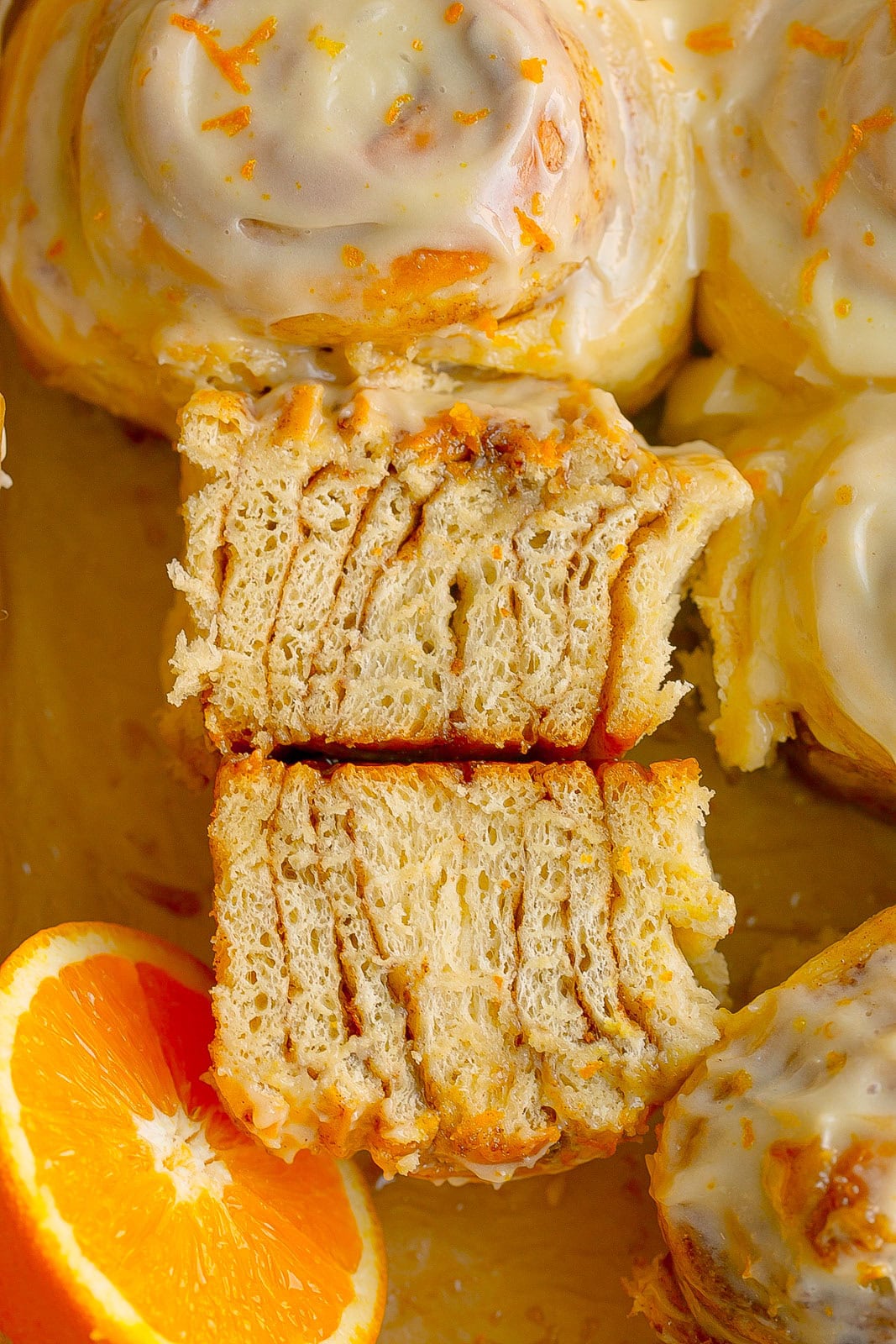 An Orange Cinnamon Roll cut in half.