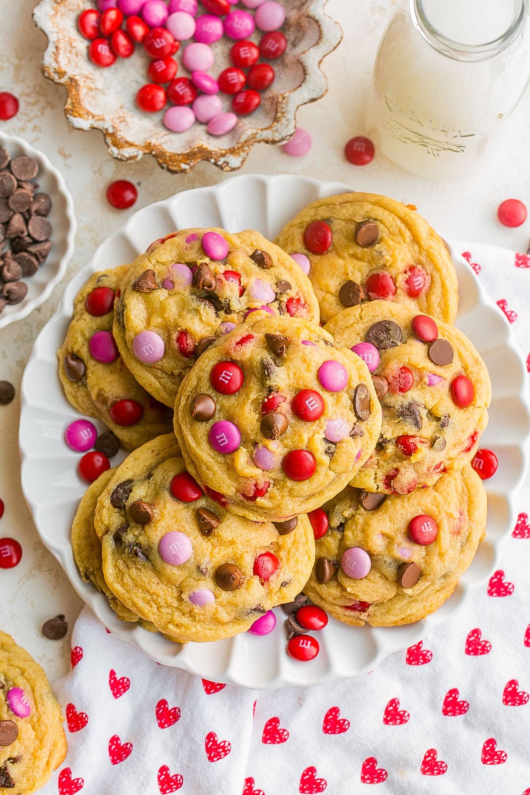 A plate full of bakery style m&m cookies.
