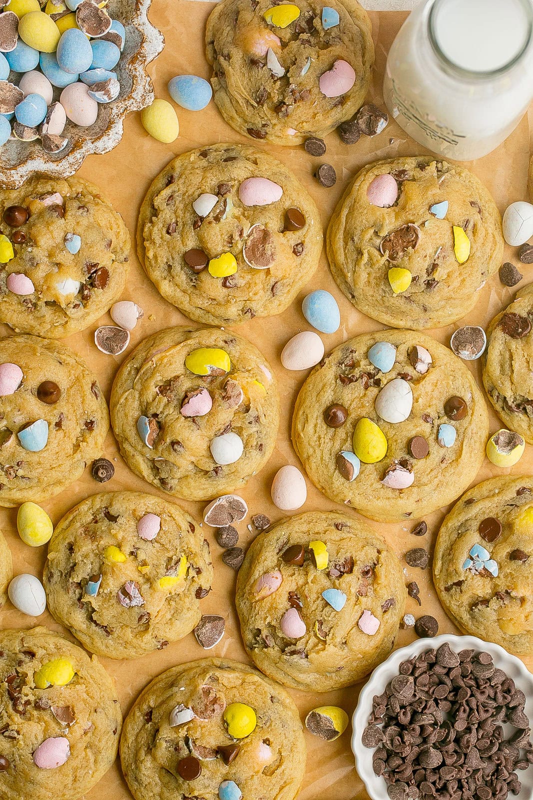 Cadbury Egg Cookies with chocolate chips on parchment paper.