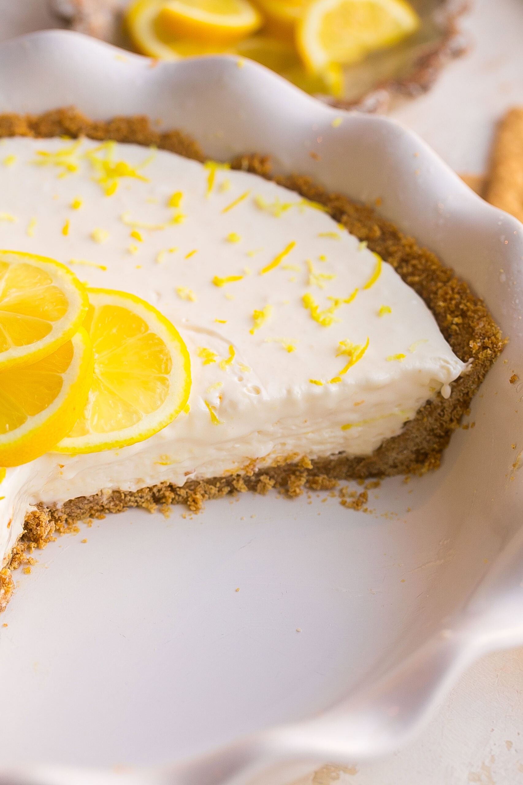 Easy Lemonade Pie with Cream Cheese served chilled with lemon zest and lemon garnish.