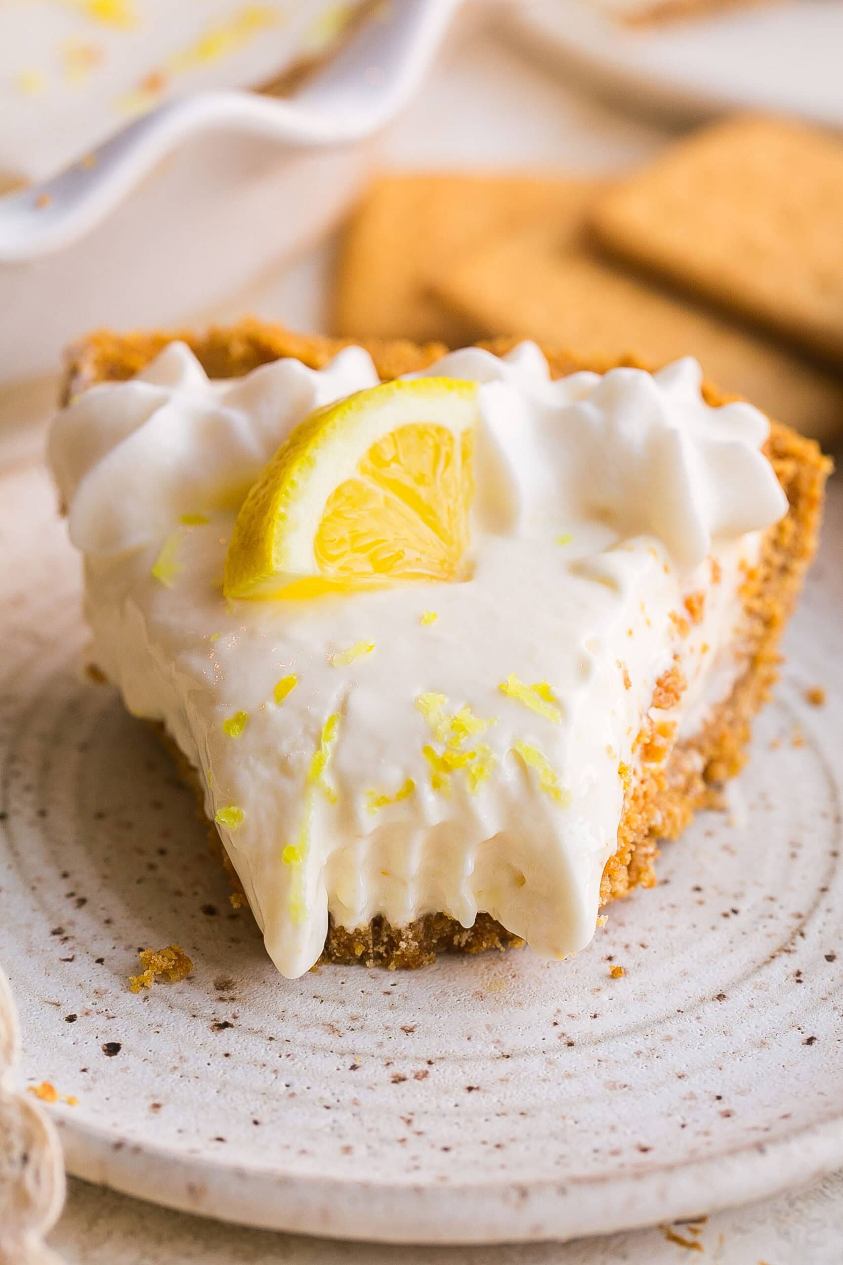 Close up of creamy Lemonade Pie filling with fork mark, made with frozen lemonade concentrate and cream cheese.