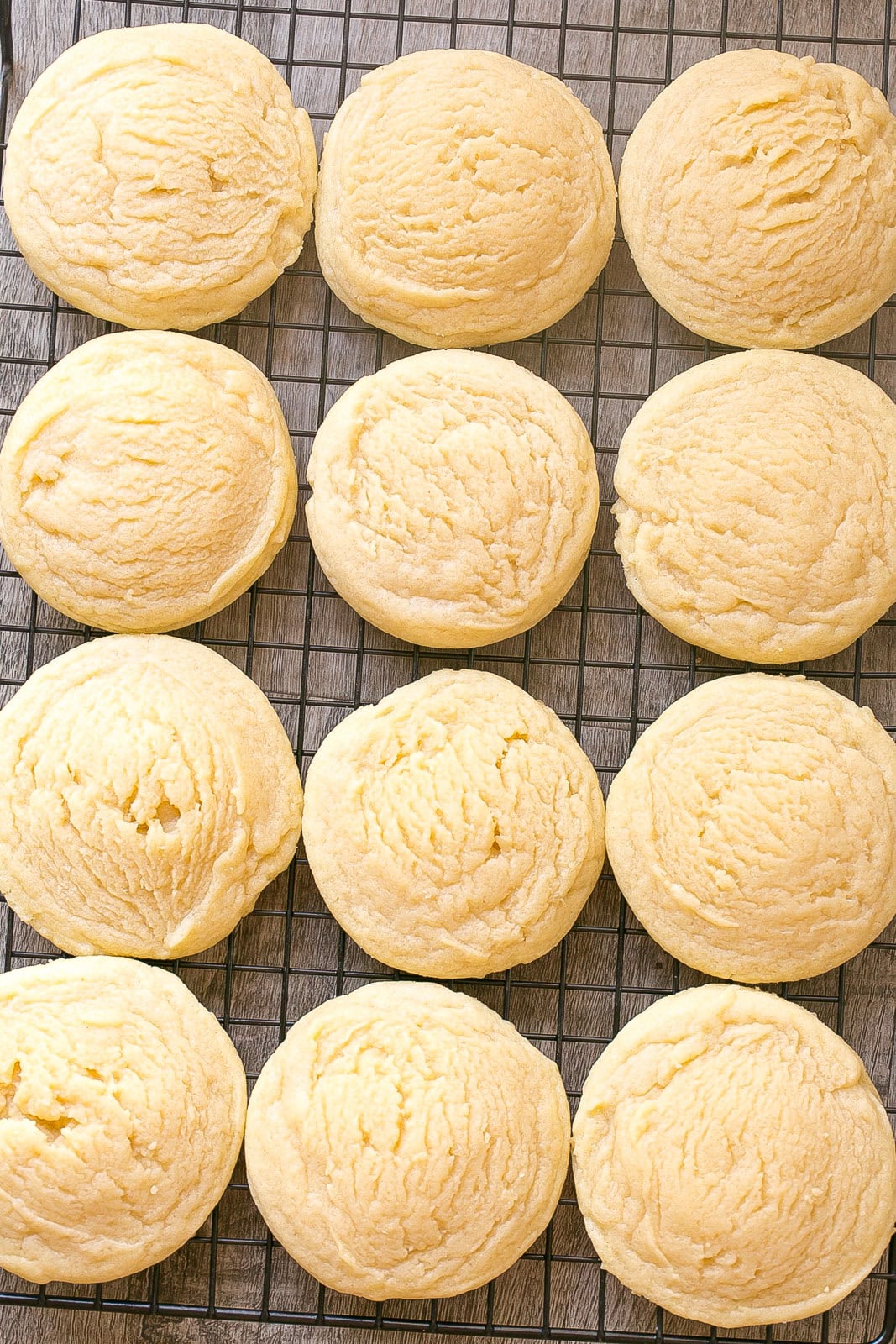A batch of easy almond sugar cookies on a cooling rack.
