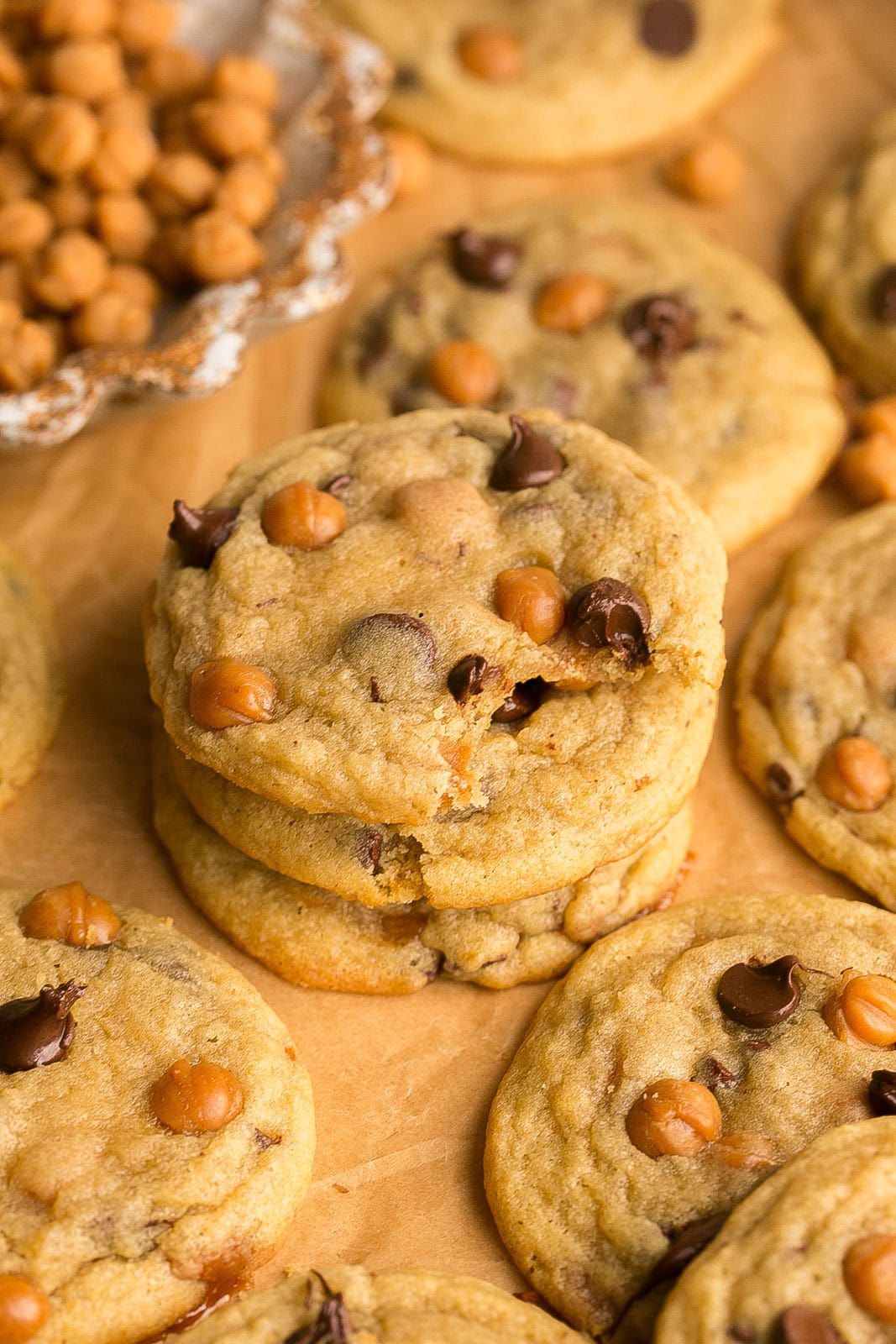 Stacked Caramel Chocolate Chip Cookies with a bite mark.