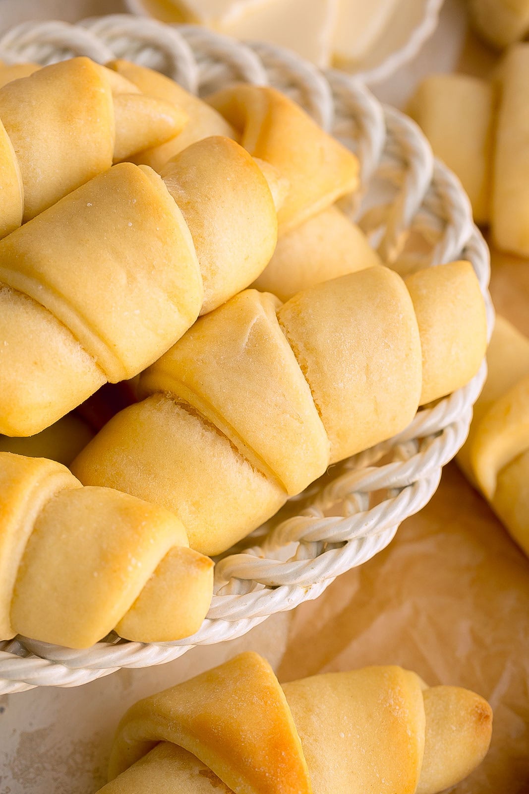 Soft crescent rolls in a bread basket.