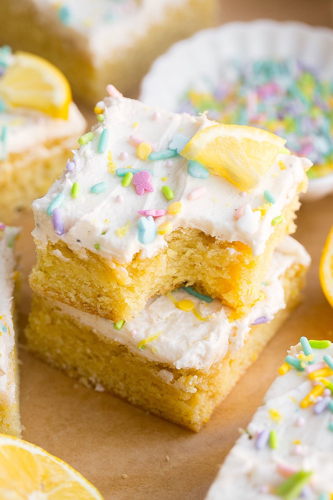 Close up of stacked soft lemon sugar cookie bars with bite mark.