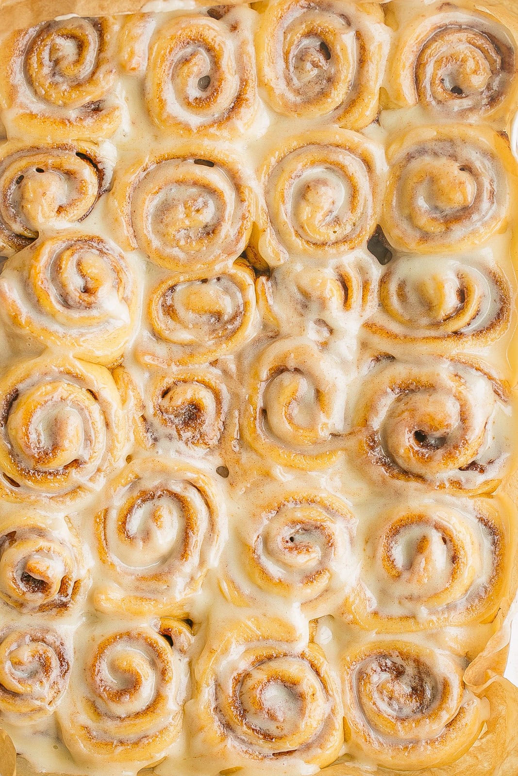 Mini Cinnamon Rolls smothered with frosting on top.