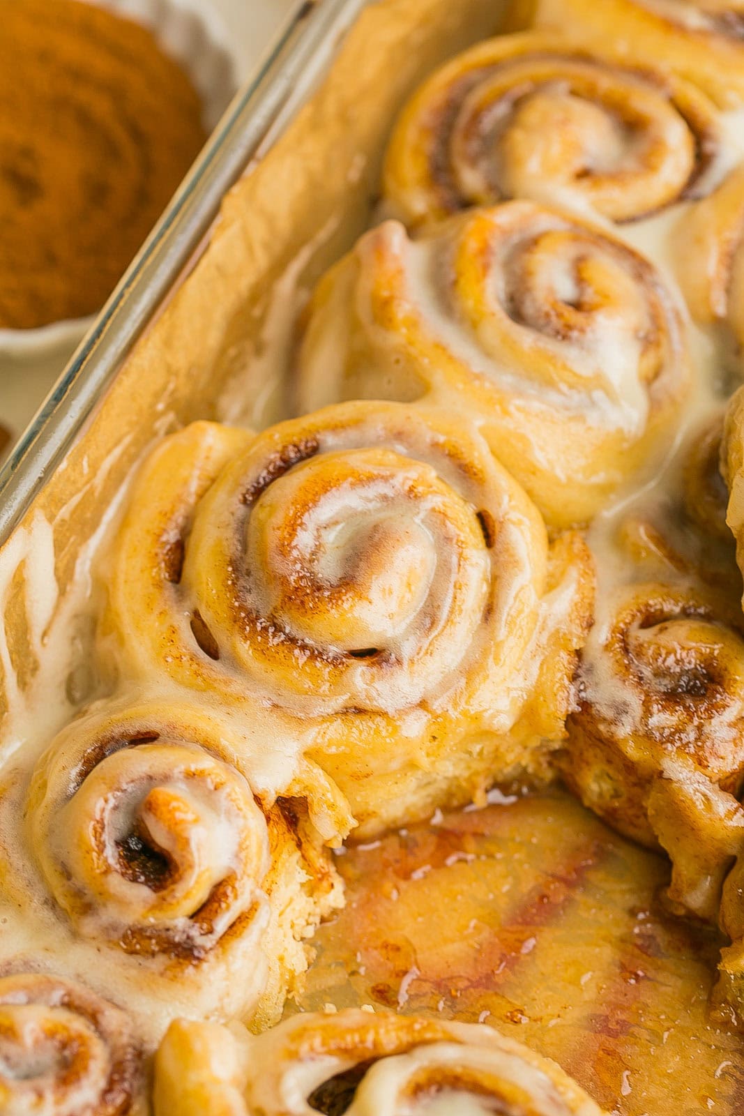 The perfect batch of cinnamon rolls in a pan.