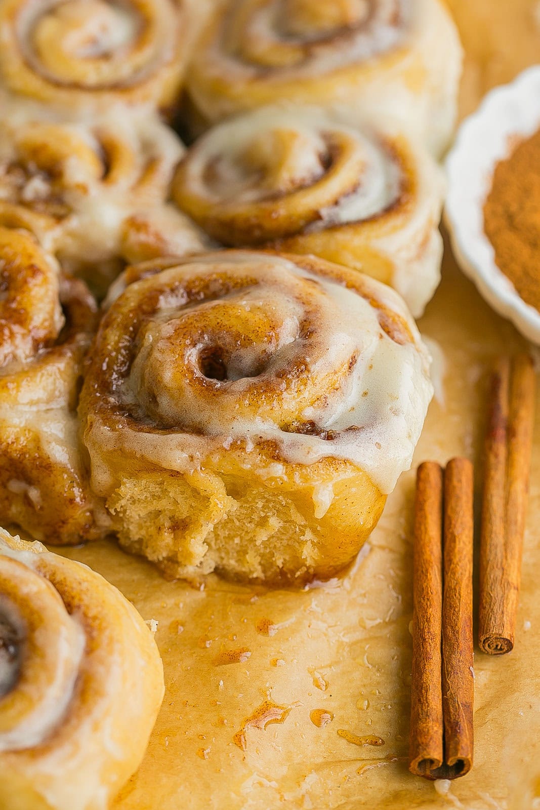 A gooey cinnamon roll with frosting on top.