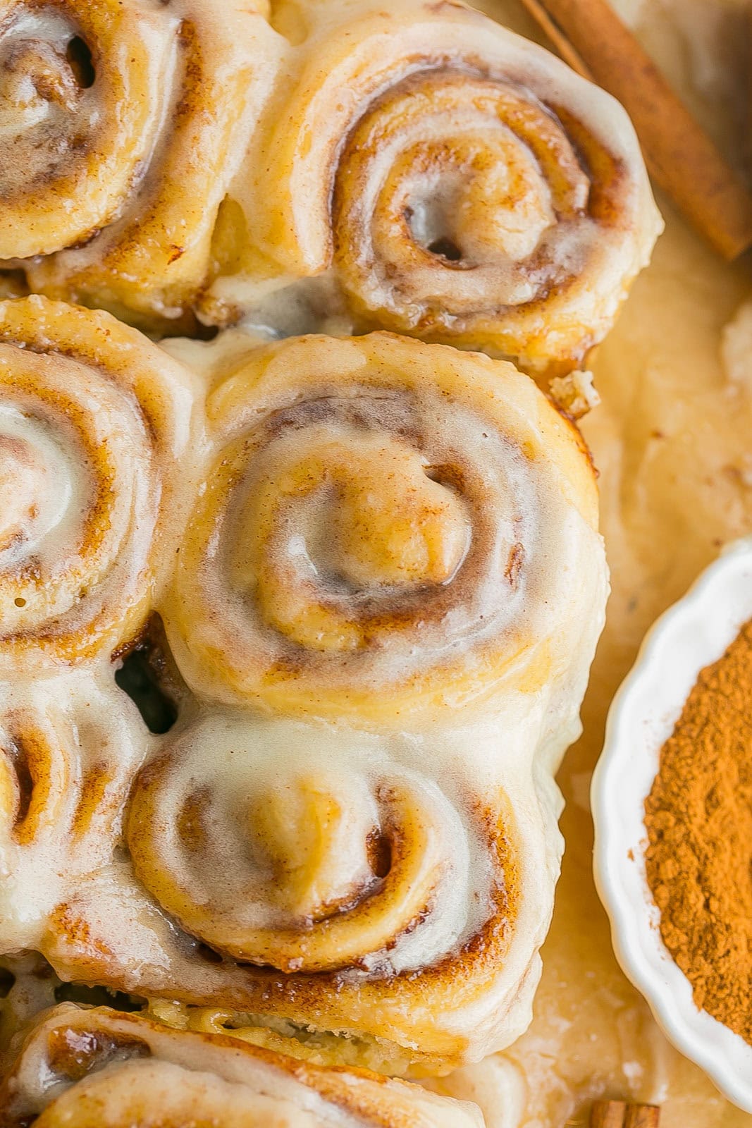 Small cinnamon rolls on parchment paper.