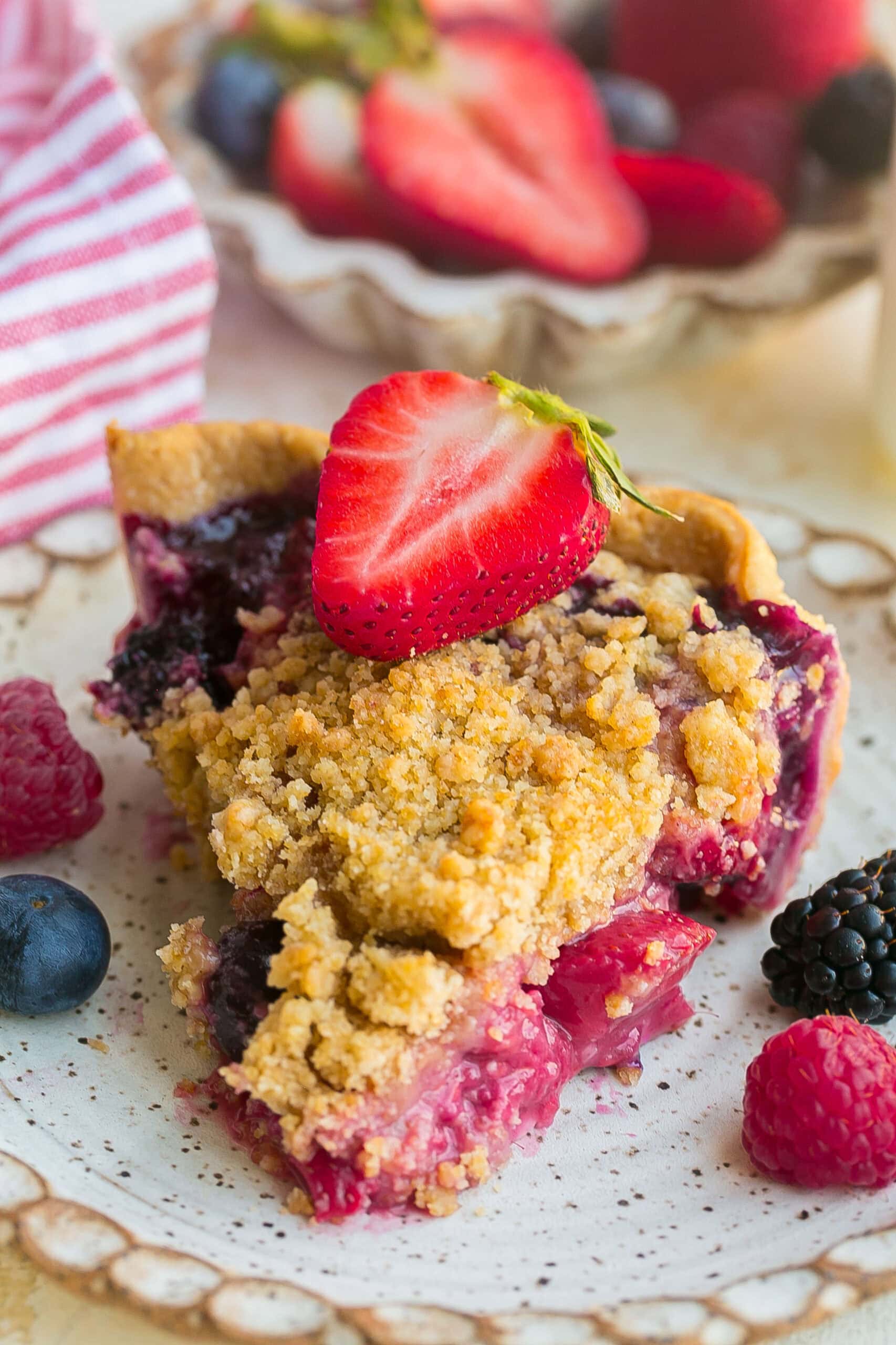 Slice of homemade Berry Crumble Pie on a plate.