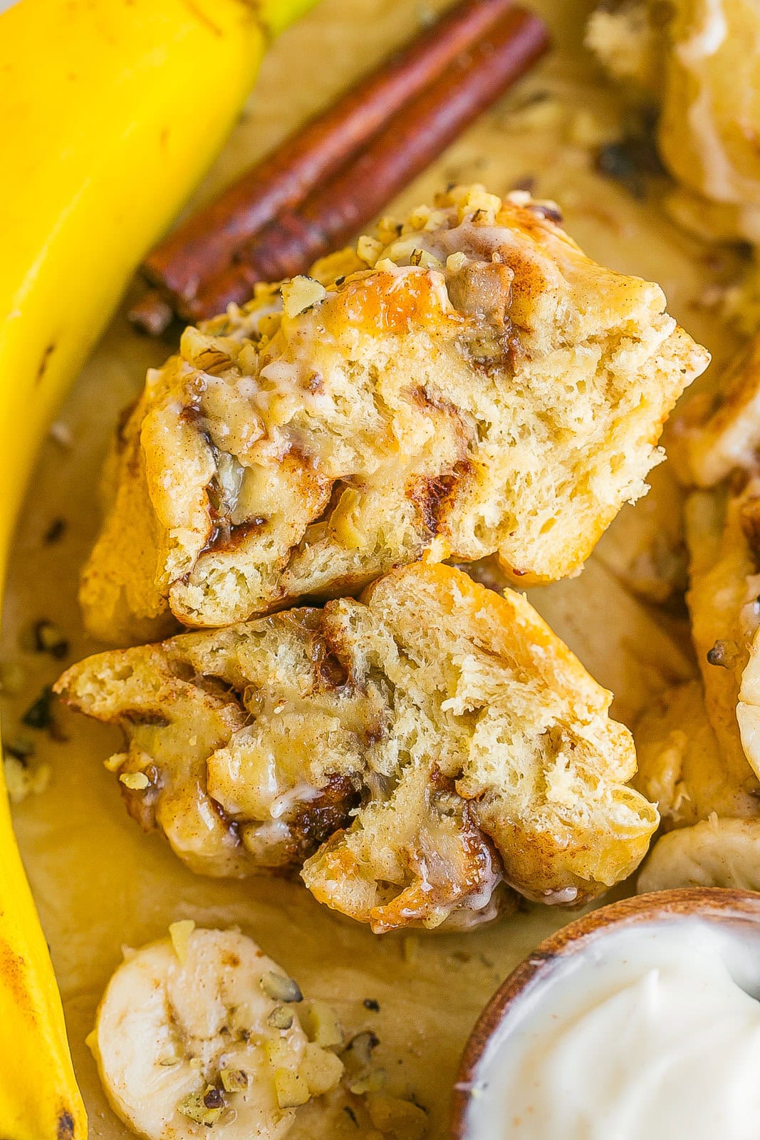 Banana Cinnamon Roll cut in half with a gooey and soft center.
