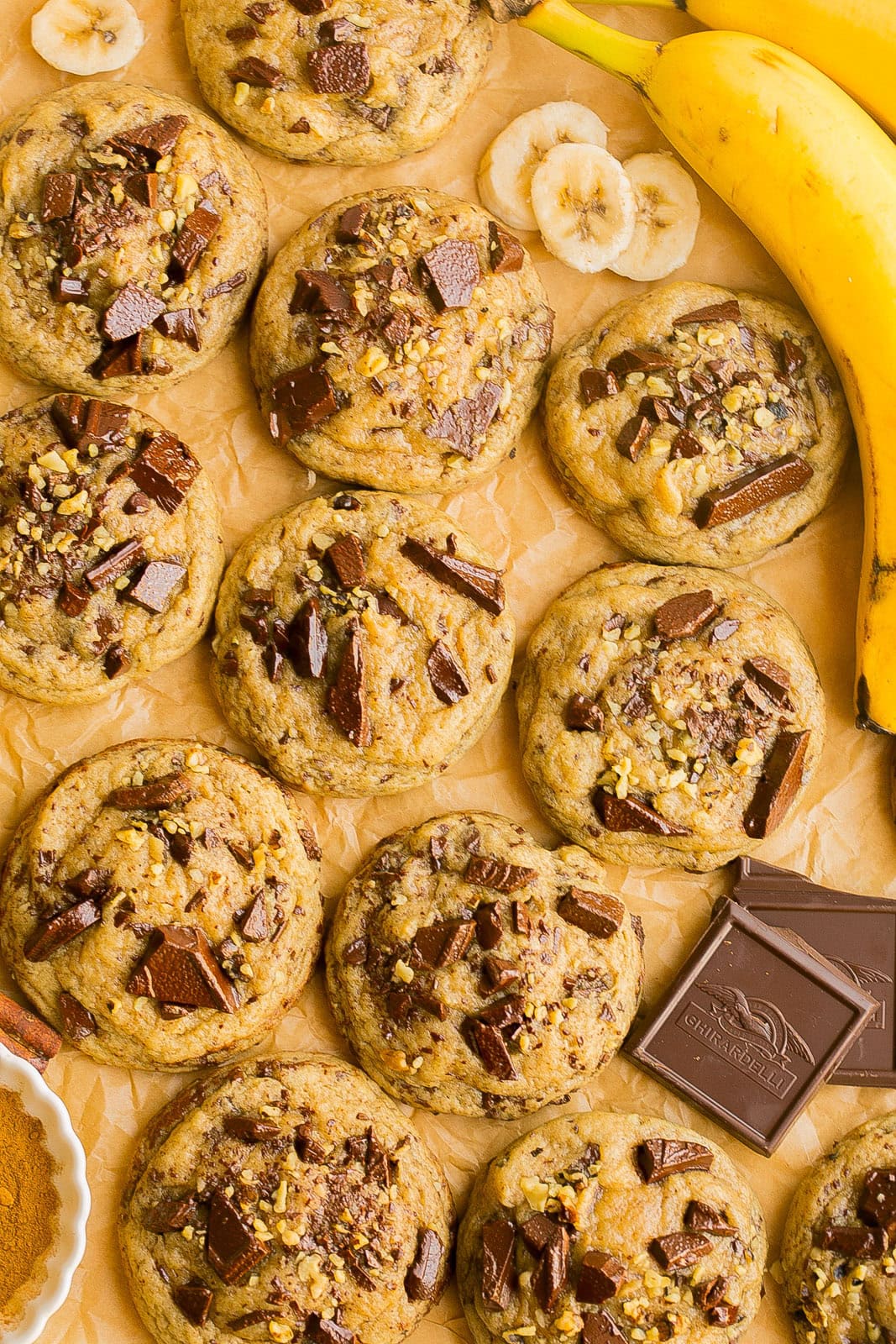 A fresh batch of Chocolate Chip Banana Cookies on parchment paper.