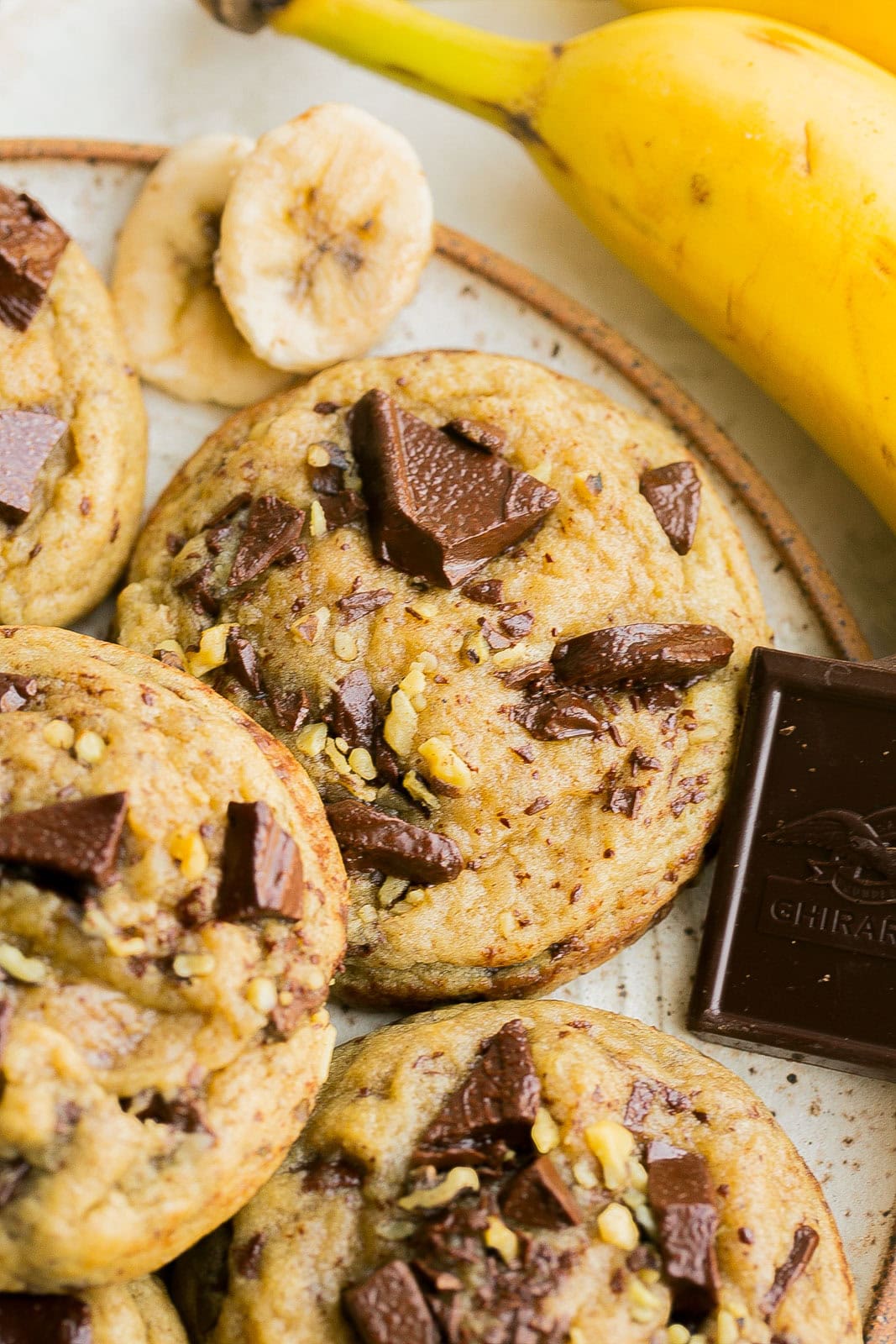 Close-up of soft Banana Bread Chocolate Chip Cookies with melty chocolate chunks and banana slices.