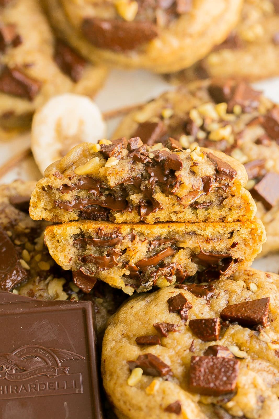 Banana chocolate chip cookie with soft centers and crisp golden edges cut in half.