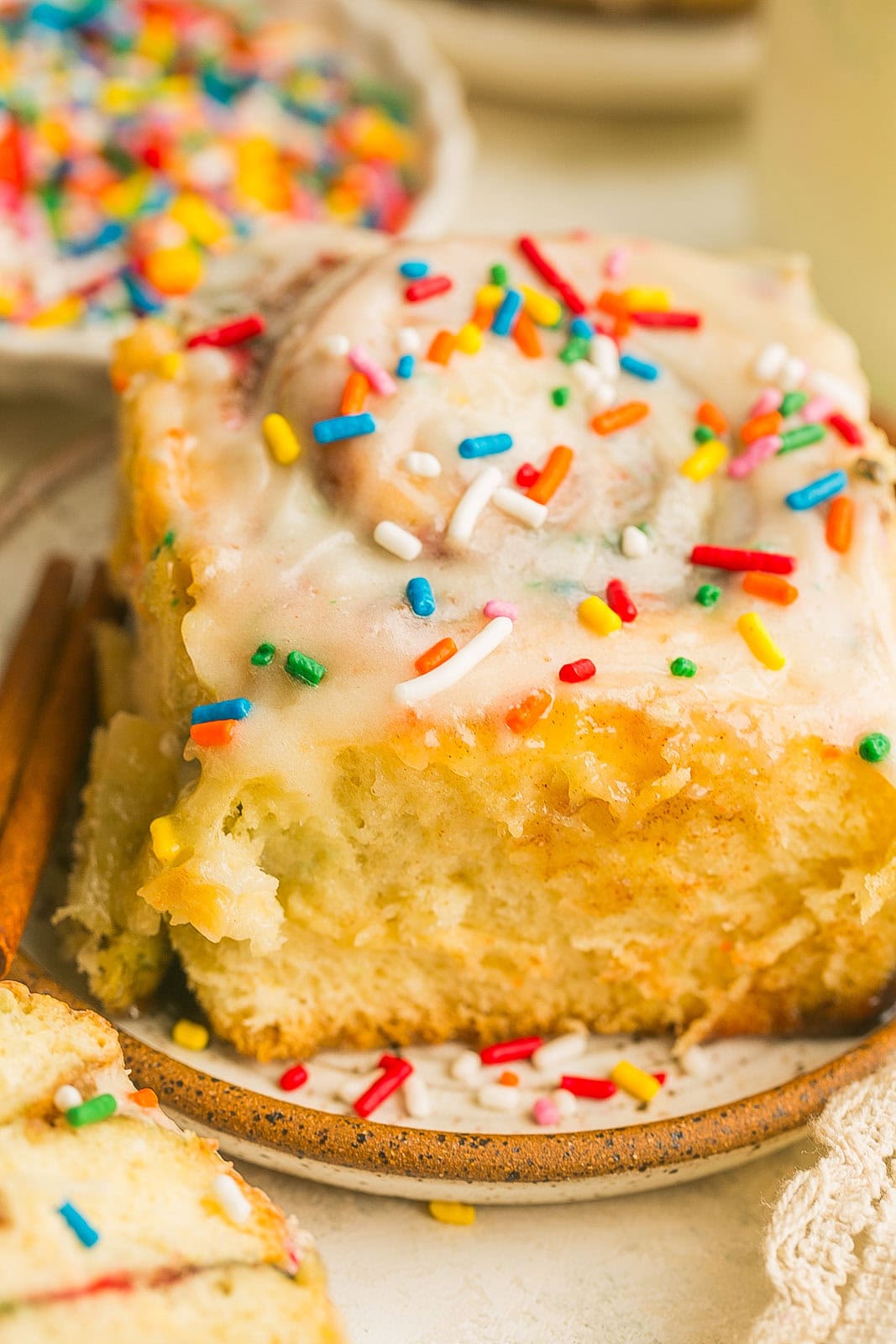 Close up of festive cinnamon roll with sprinkles served warm for breakfast or brunch.