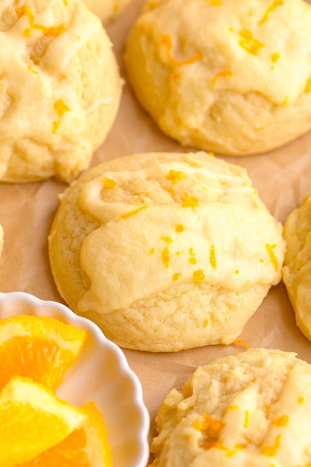 Bakery-style orange sugar cookies styled for spring baking with frosting.