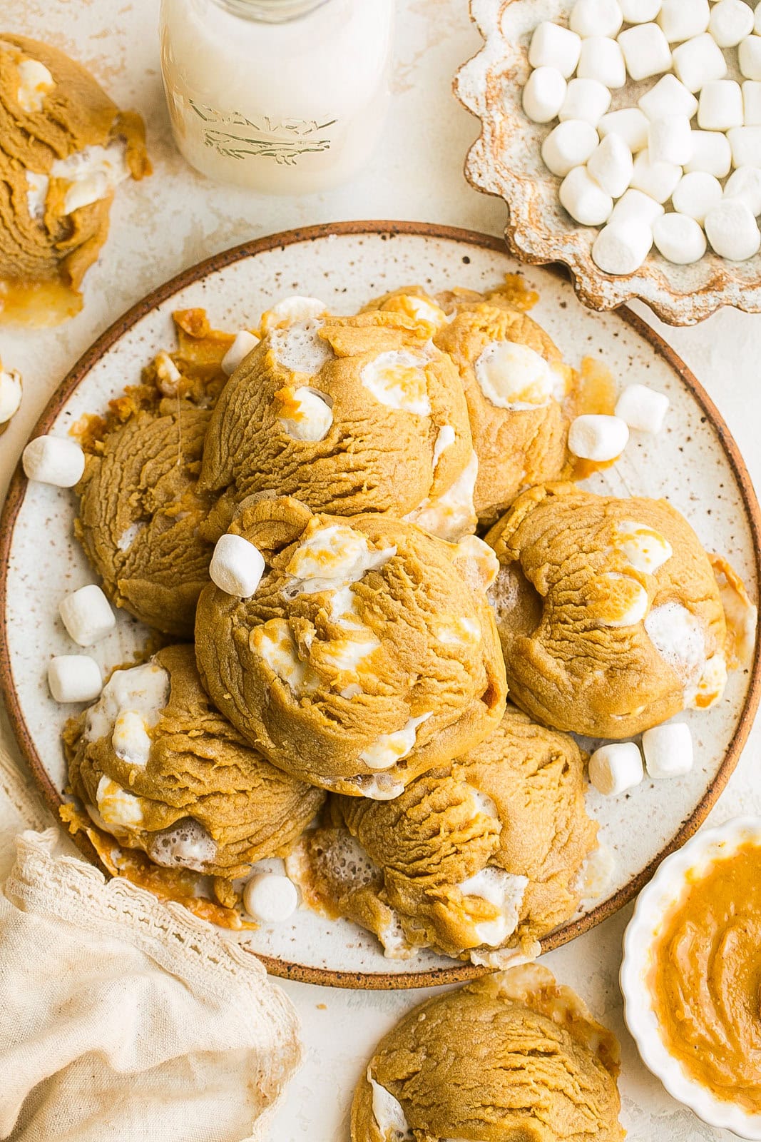 Gooey Peanut Butter Marshmallow Cookies on a plate served warm with a glass of milk.