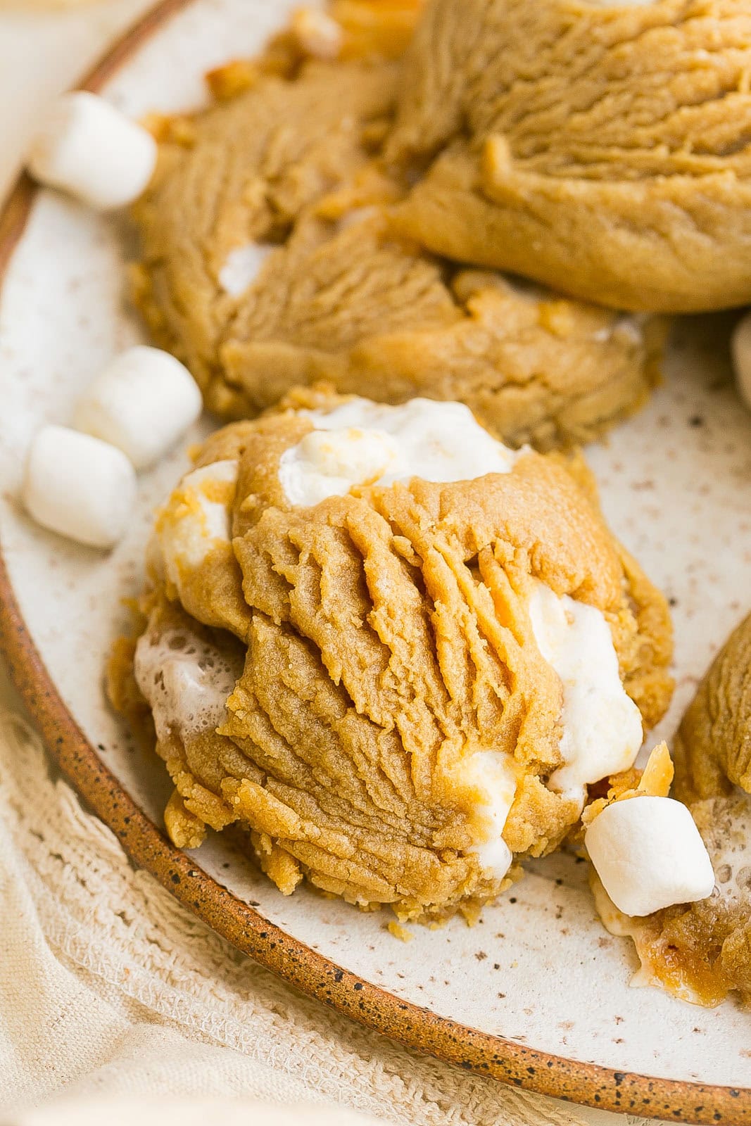 Bakery-style Peanut Butter Marshmallow Cookies on a plate loaded with mini marshmallows.