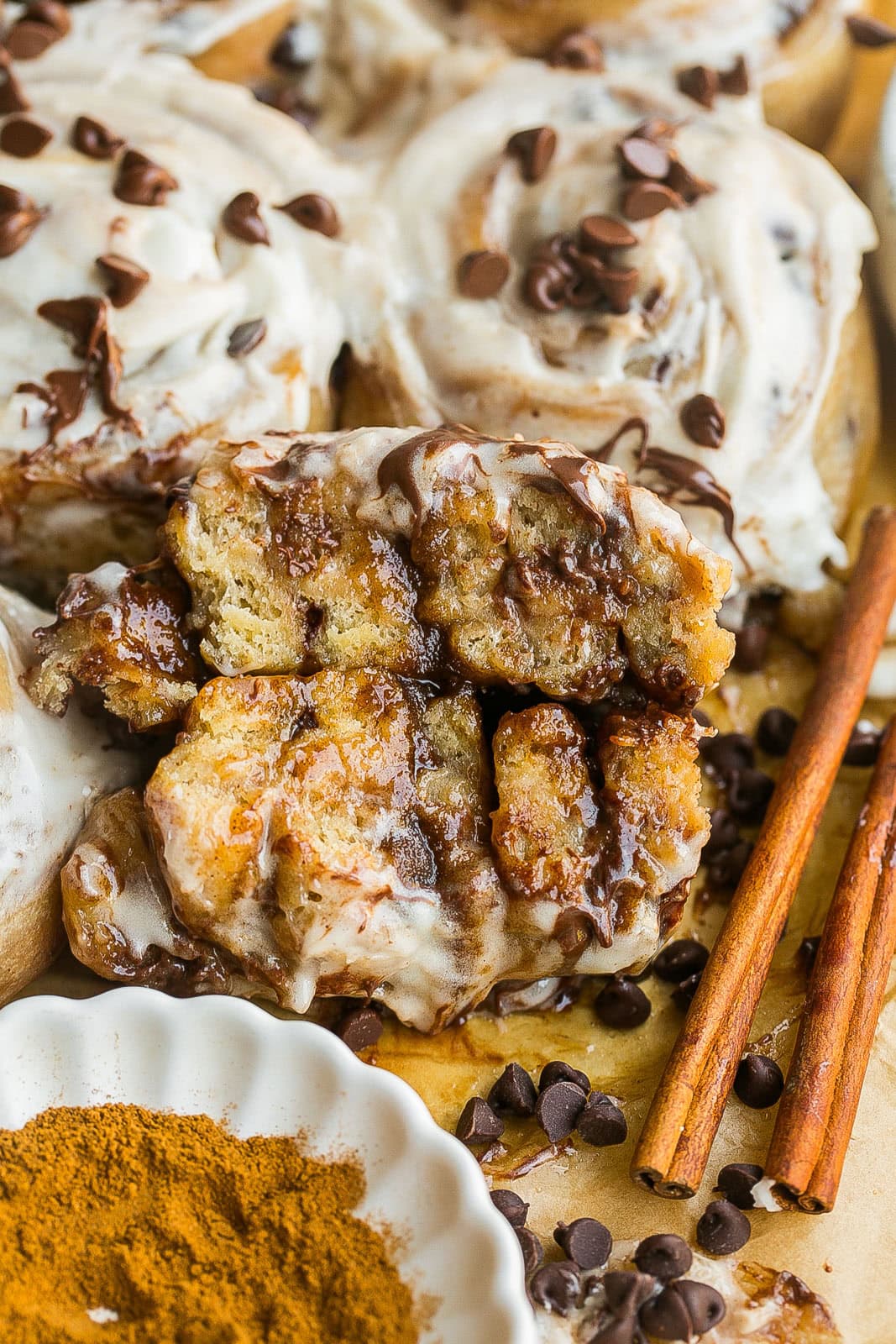 Gooey homemade cinnamon rolls cut in half filled with chocolate chips.