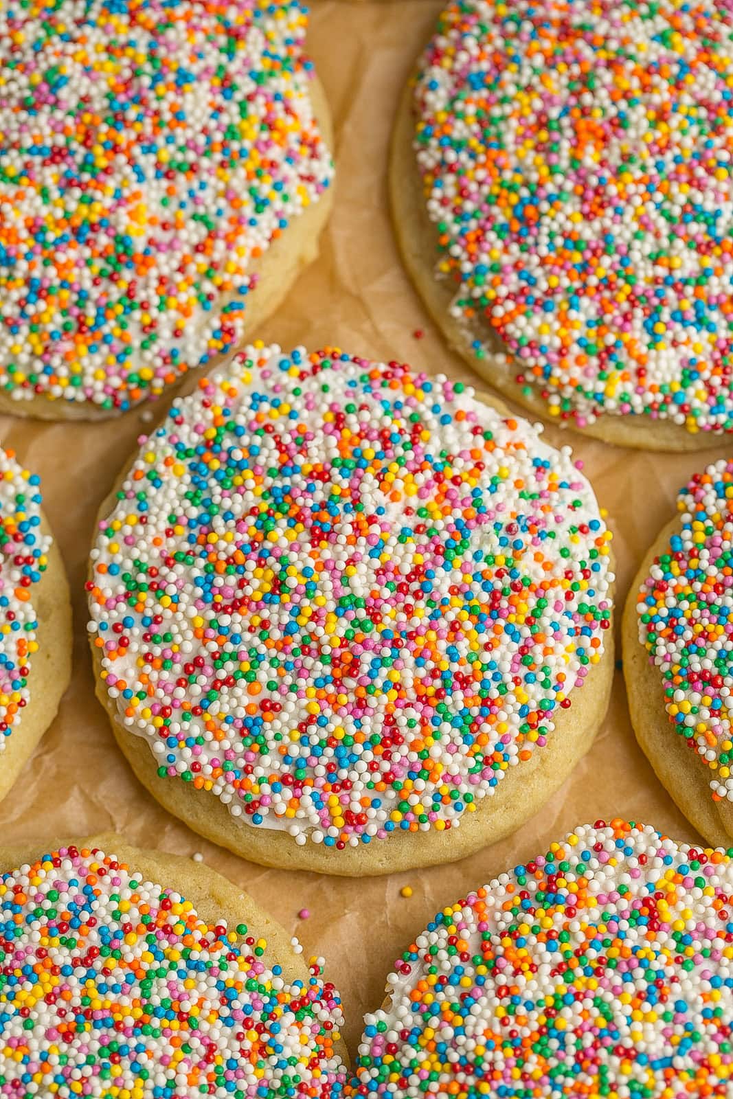 Soft and chewy sugar cookies frosted with homemade buttercream and dipped in rainbow sprinkles.