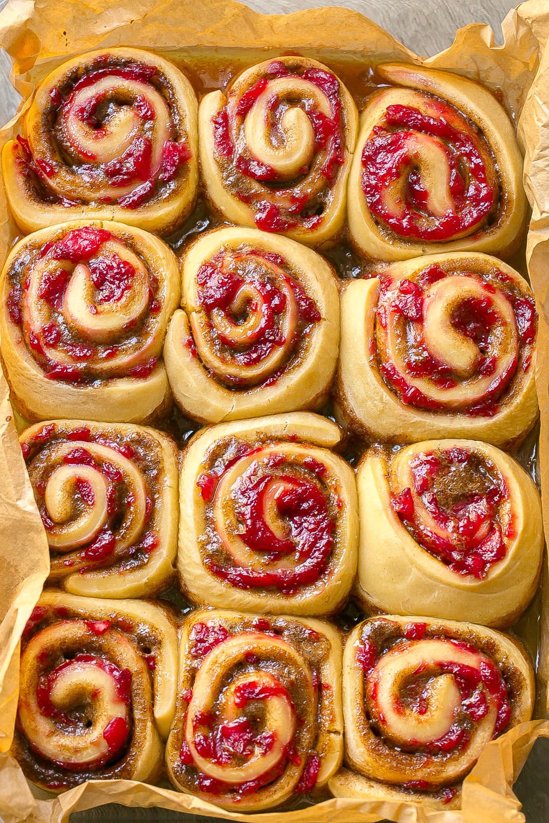 Warm homemade unfrosted cinnamon rolls filled with strawberries and cinnamon sugar.