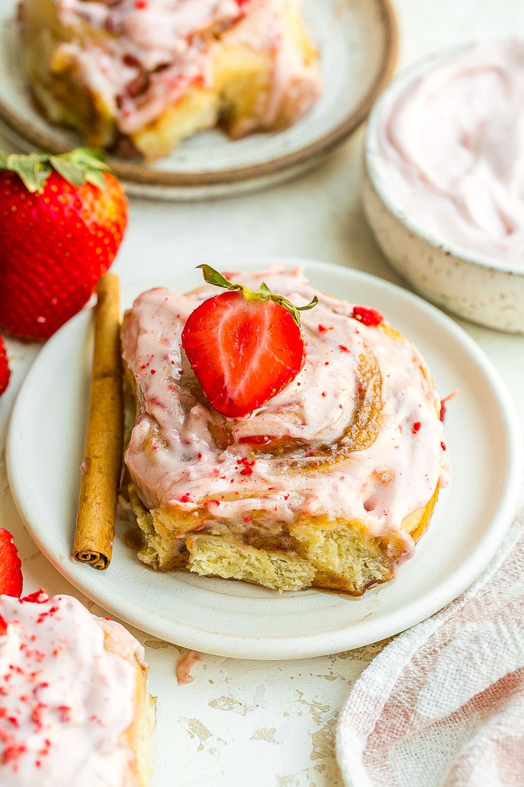 Gooey Strawberry Cinnamon Rolls served on a white plate.