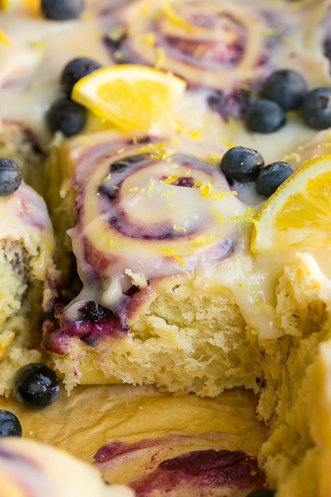 Fluffy lemon sweet roll filled with juicy blueberries and topped with lemon cream cheese icing.