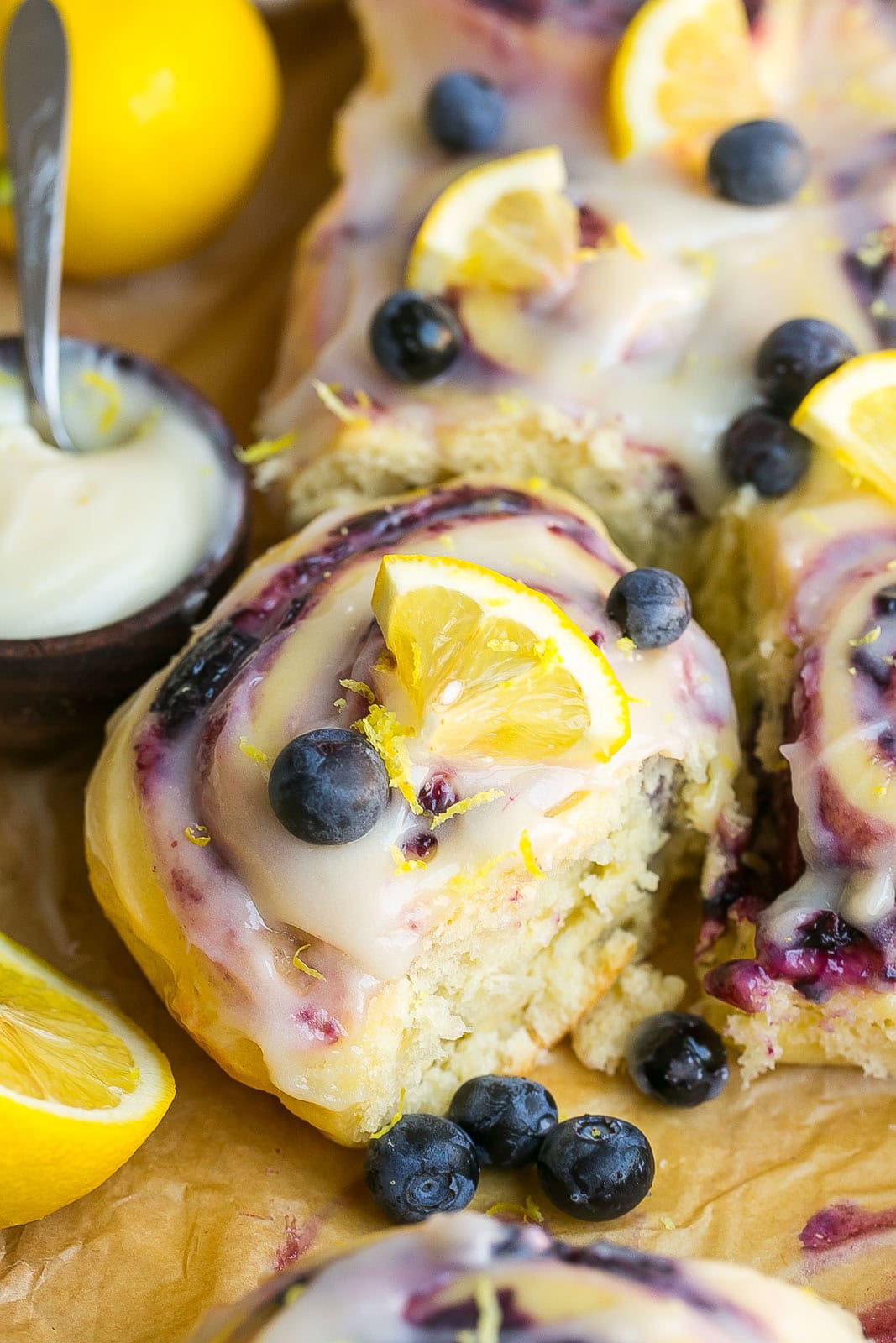 Soft blueberry lemon sweet roll with homemade blueberry jam filling and cream cheese frosting.