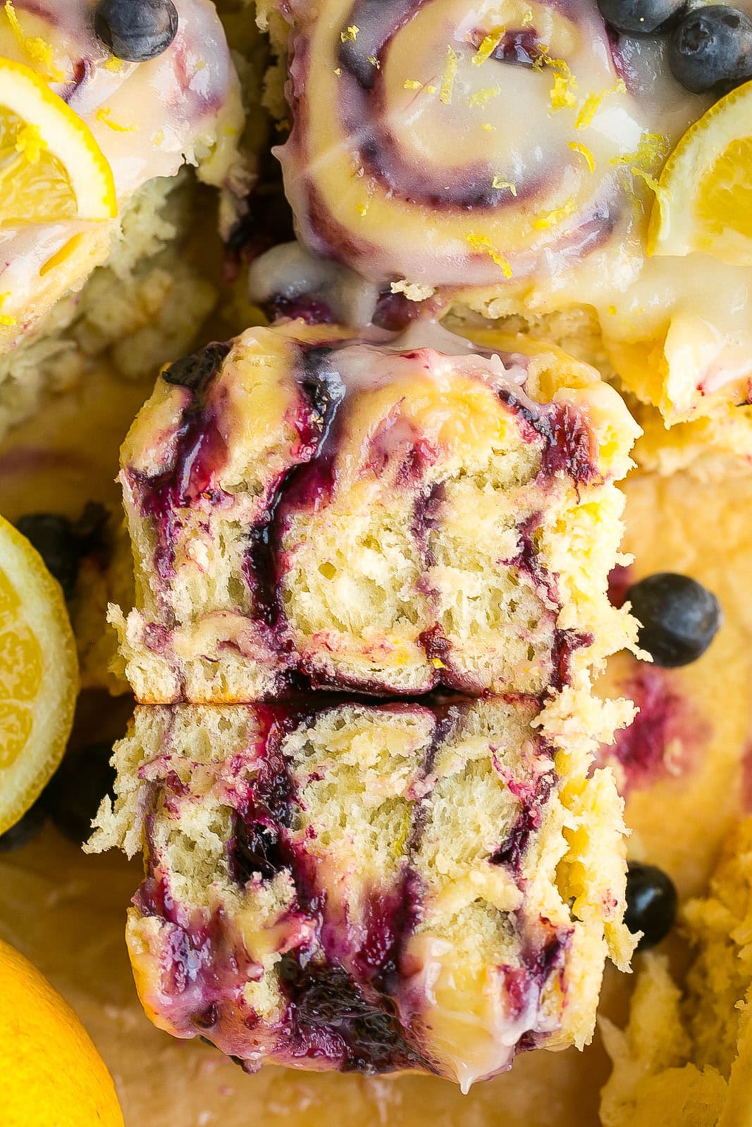 A soft and fluffy sweet roll filled with blueberry jam and topped with lemon frosting.