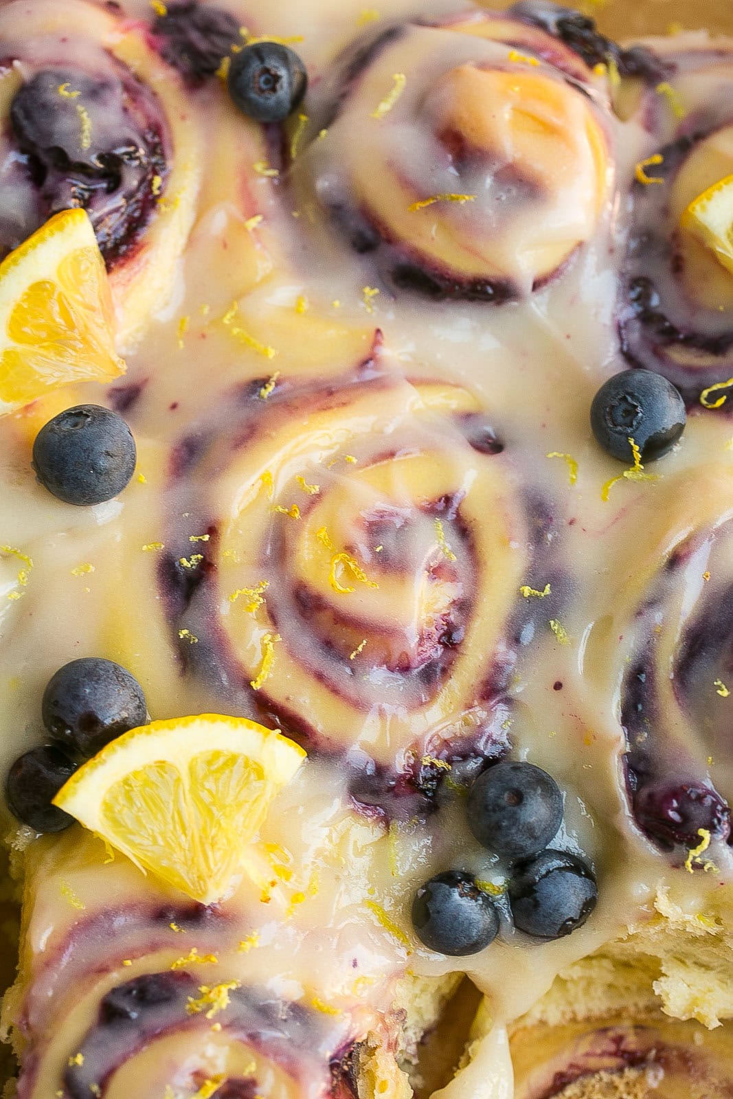 Homemade blueberry lemon sweet rolls with lemon cream cheese frosting and fresh blueberries.