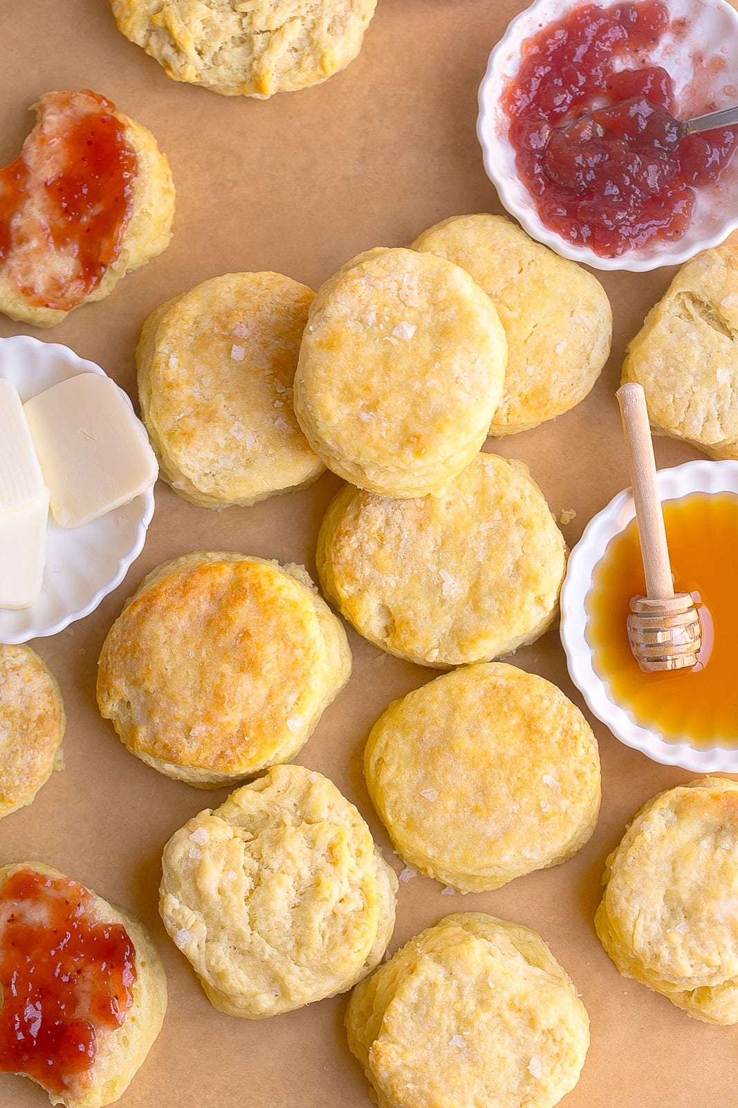 Soft, flaky Homemade Buttermilk Biscuits fresh from the oven with honey, butter and jam.