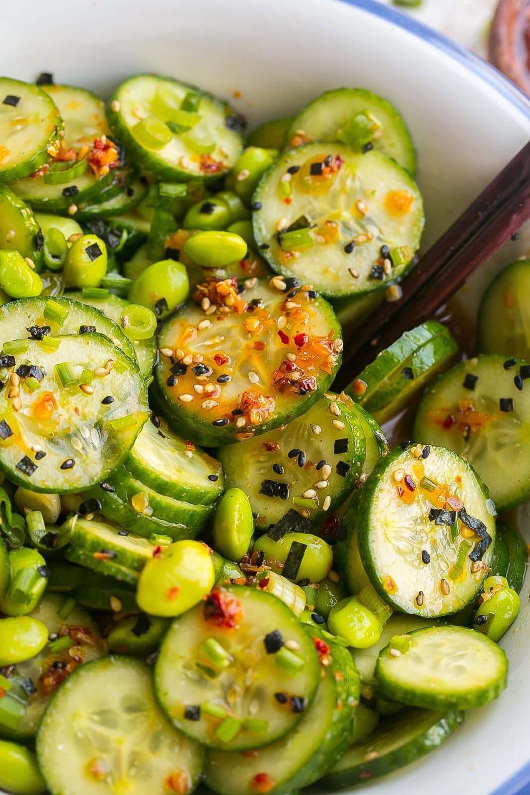 Close up of cucumbers covered in sesame ginger dressing.