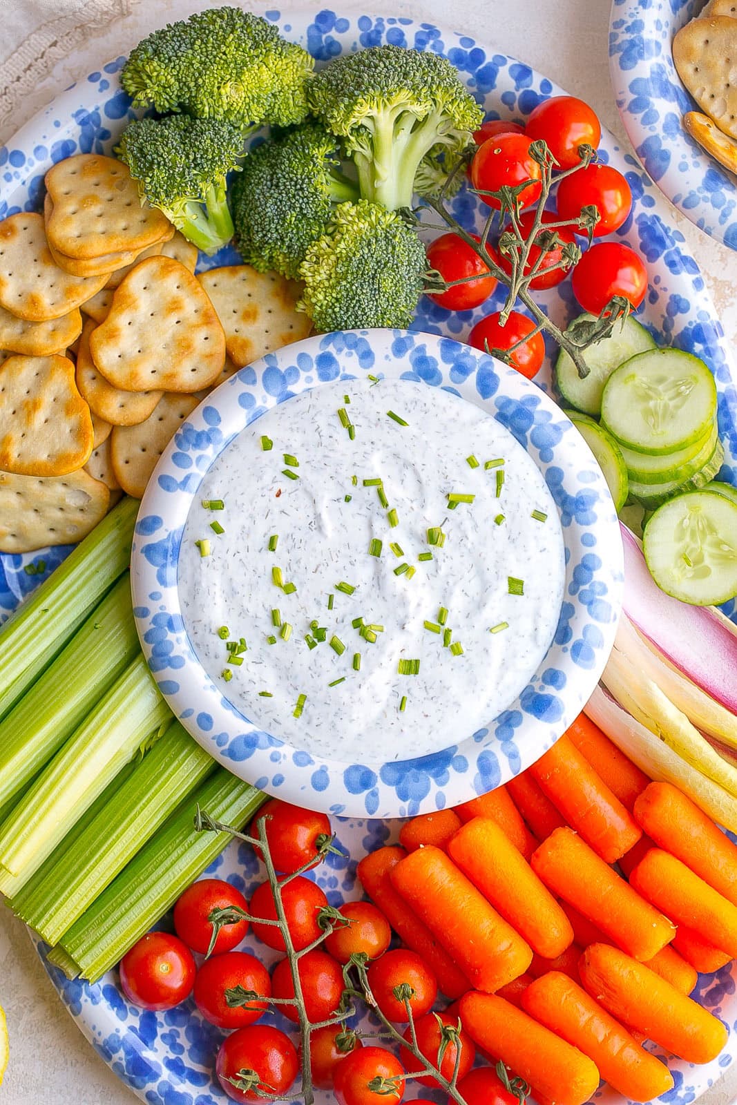 Healthy Greek yogurt ranch dip made with fresh herbs and seasonings, served alongside a colorful assortment of fresh vegetables for dipping.